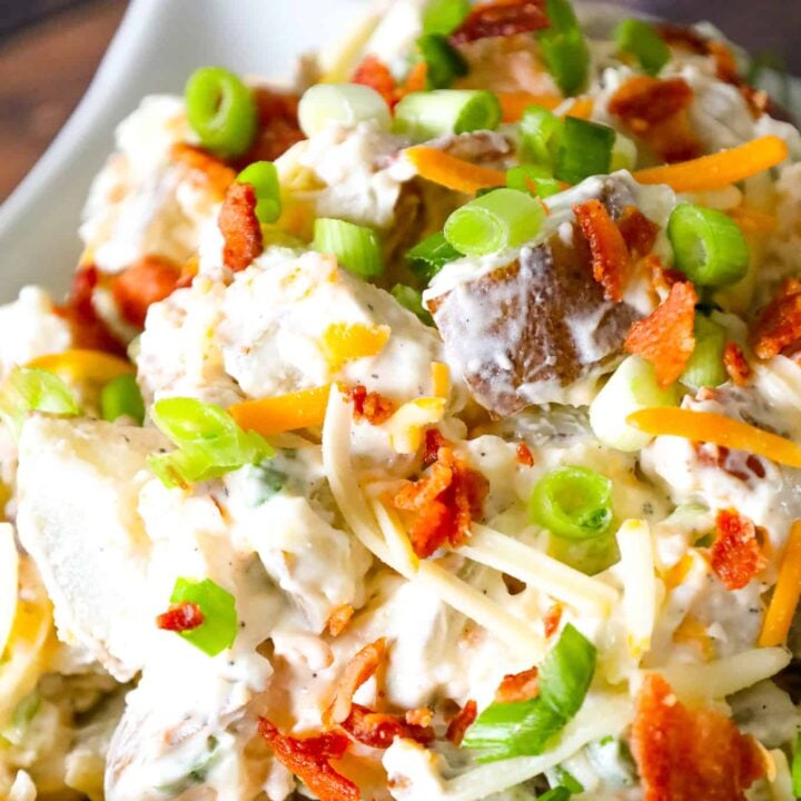 Loaded Baked Potato Salad is a delicious cold side dish recipe made with russet potatoes and loaded with mayo, sour cream, crumbled bacon, cheddar cheese and chopped green onions.