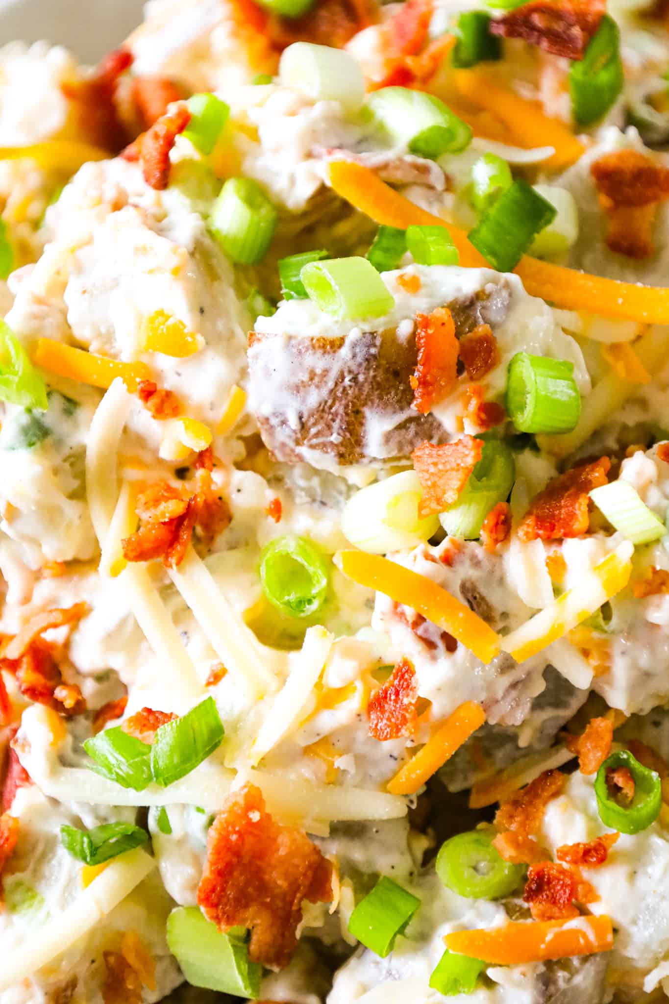 Loaded Baked Potato Salad is a delicious cold side dish recipe made with russet potatoes and loaded with mayo, sour cream, crumbled bacon, cheddar cheese and chopped green onions.