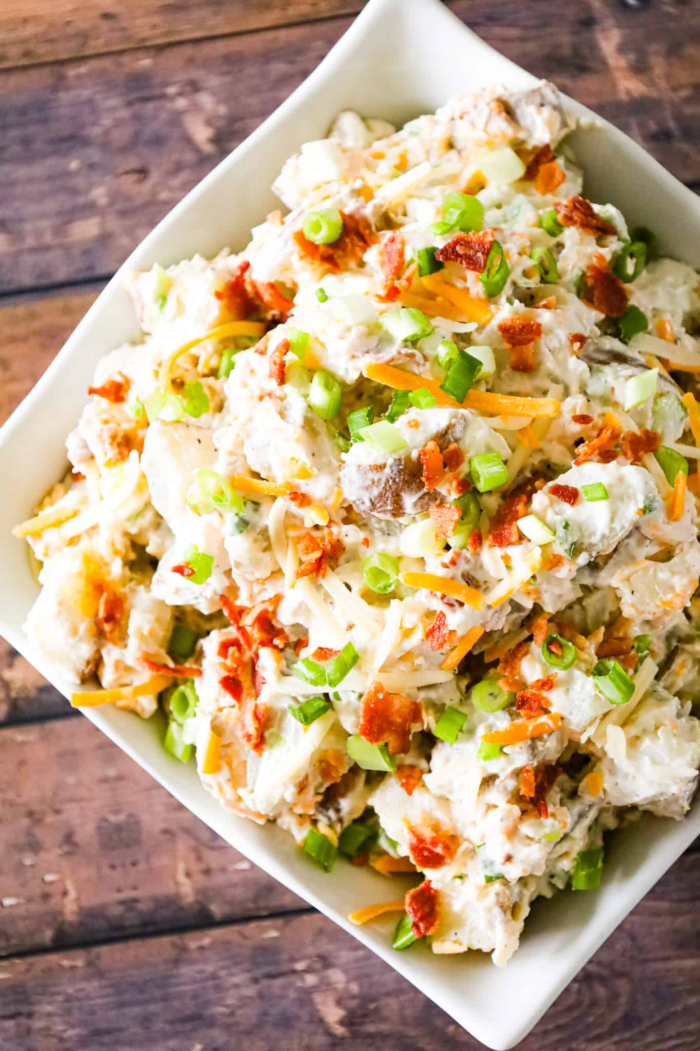 Loaded Baked Potato Salad is a delicious cold side dish recipe made with russet potatoes and loaded with mayo, sour cream, crumbled bacon, cheddar cheese and chopped green onions.