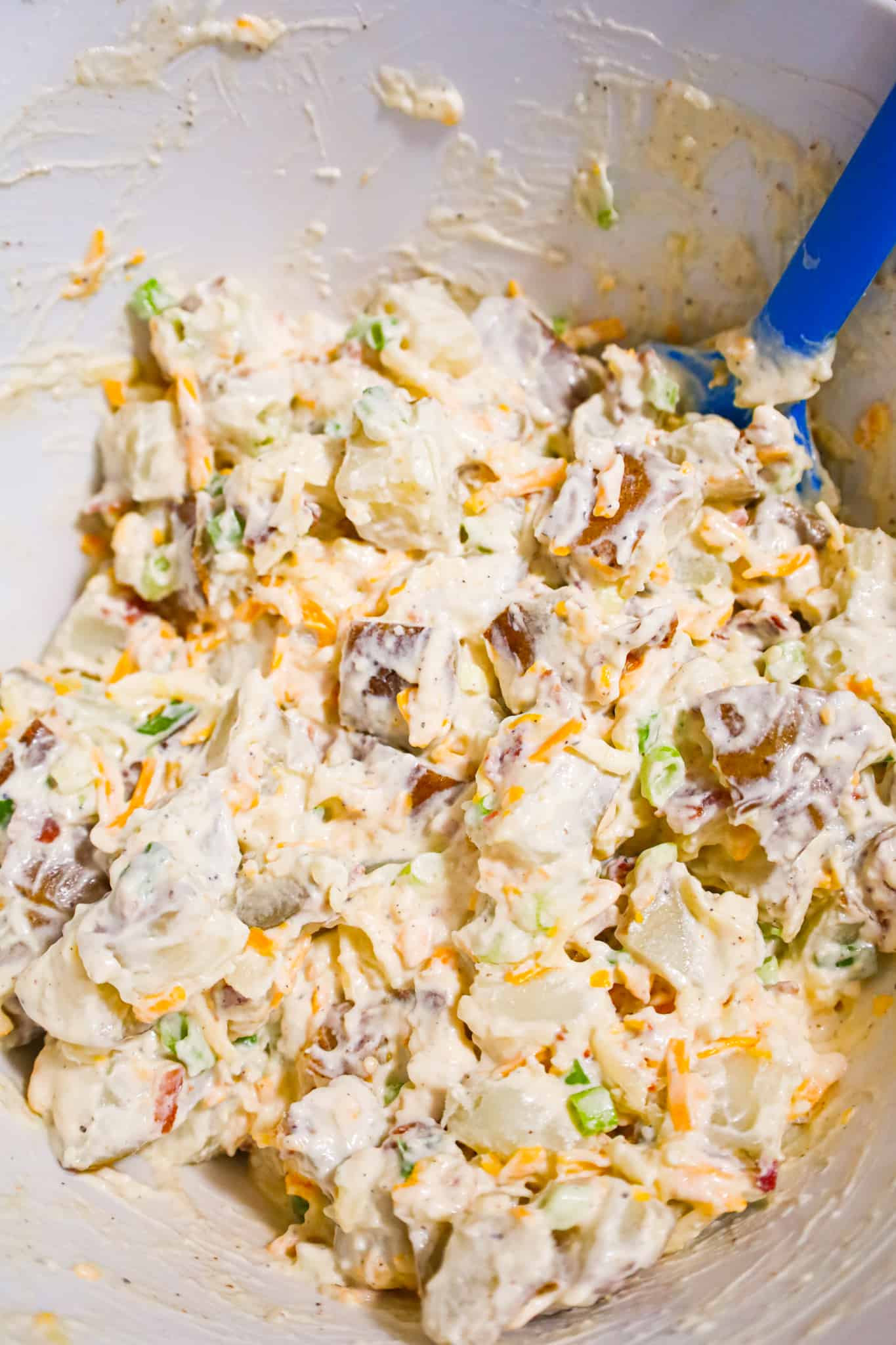Loaded Baked Potato Salad is a delicious cold side dish recipe made with russet potatoes and loaded with mayo, sour cream, crumbled bacon, cheddar cheese and chopped green onions.