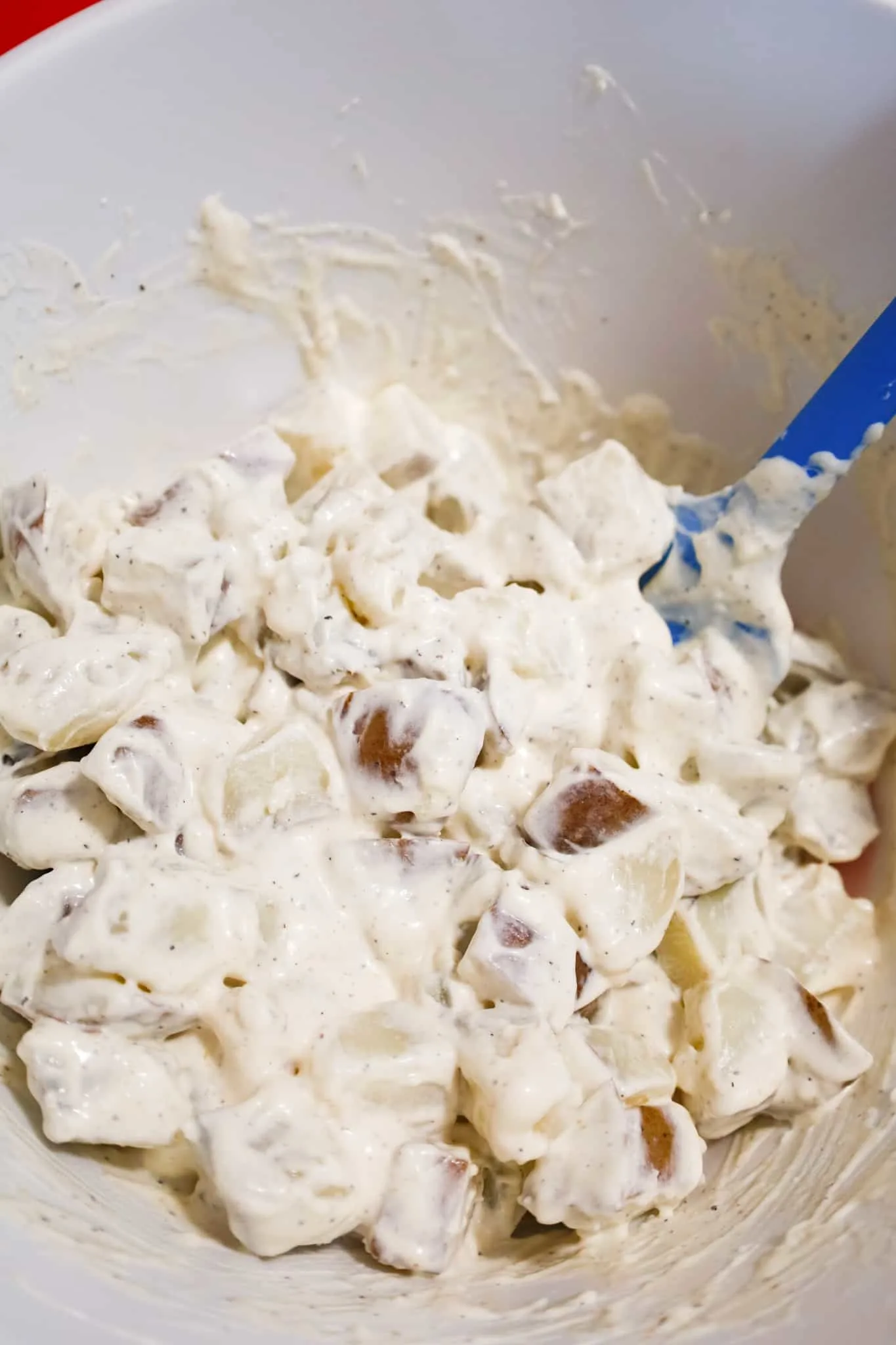 cooked diced potatoes tossed in sour cream and mayo