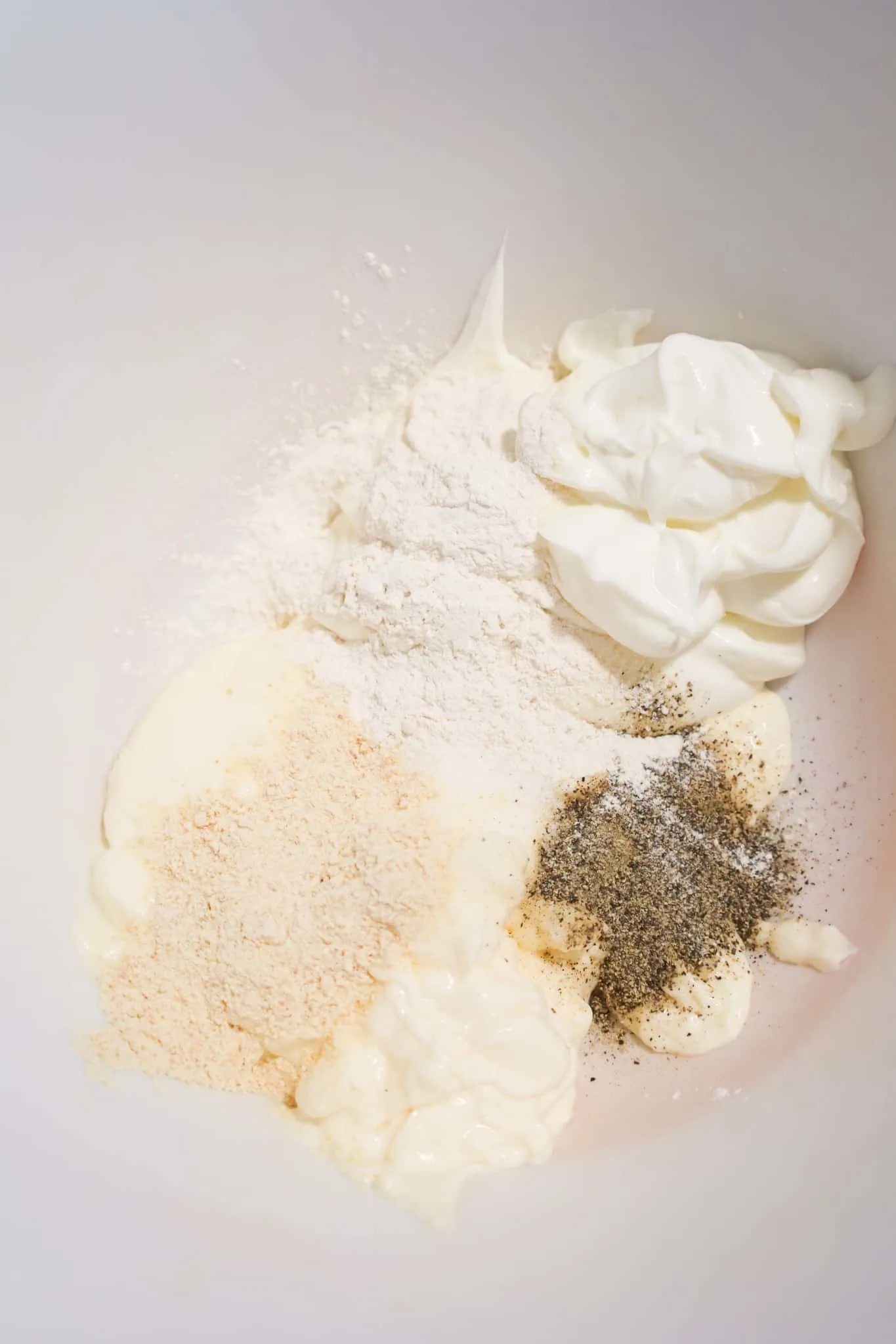 spices, sour cream and mayo in a mixing bowl