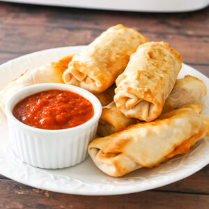 Air Fryer Pizza Rolls are an easy dinner or party food recipe using egg roll wrappers stuffed with diced pepperoni, mozzarella cheese and pizza sauce.