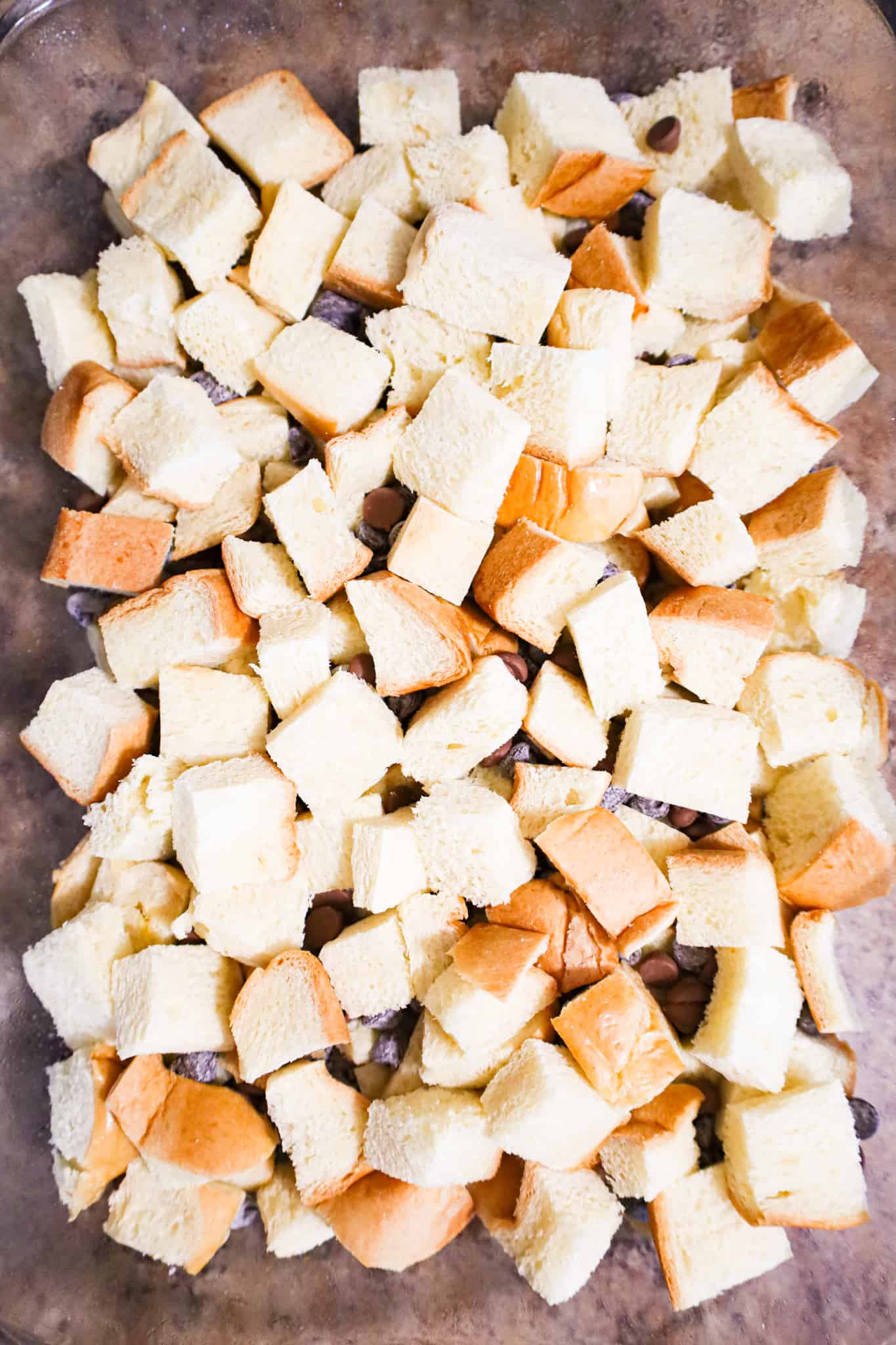 cubed brioche bread in a baking dish