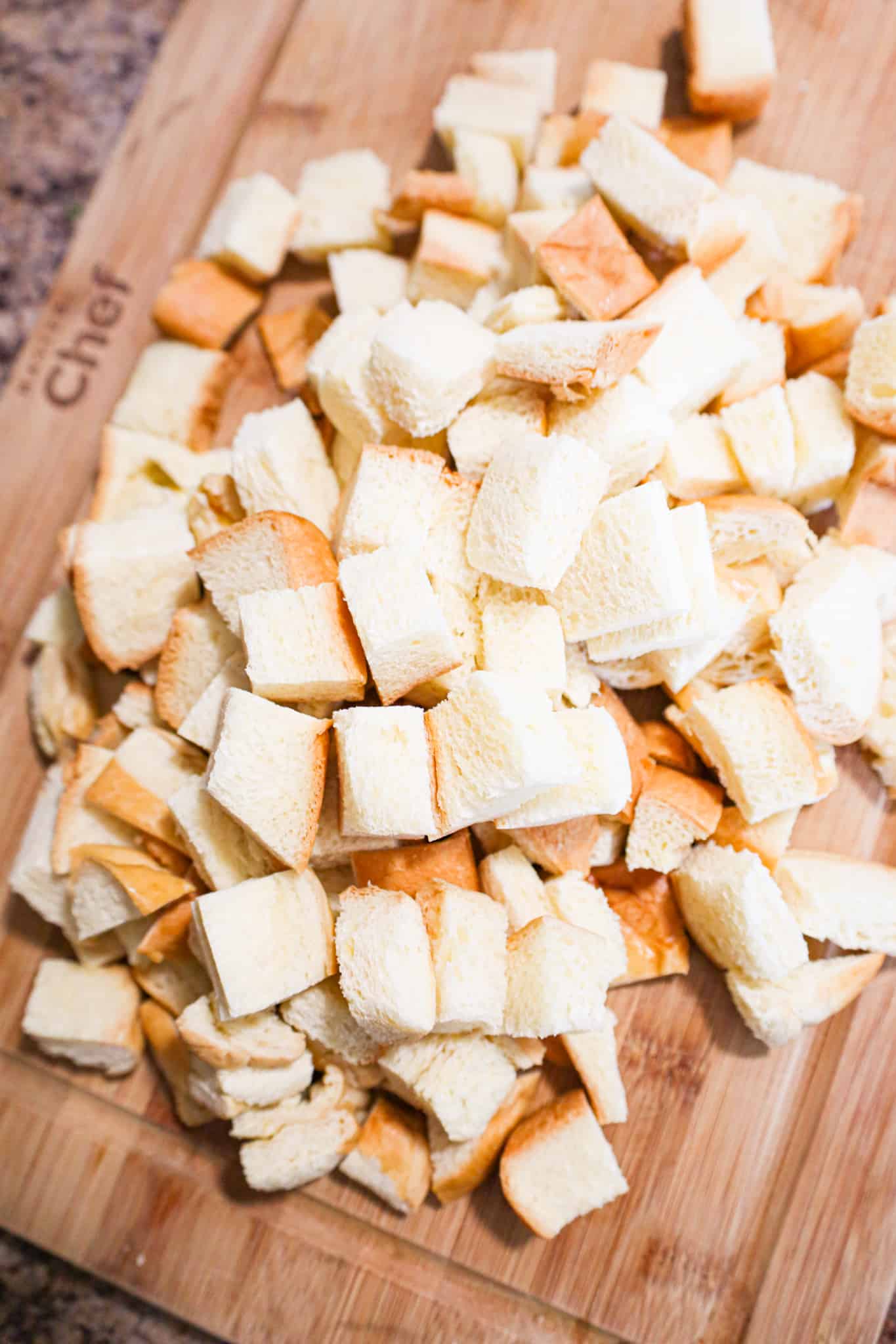 cubed brioche bread on a cutting board