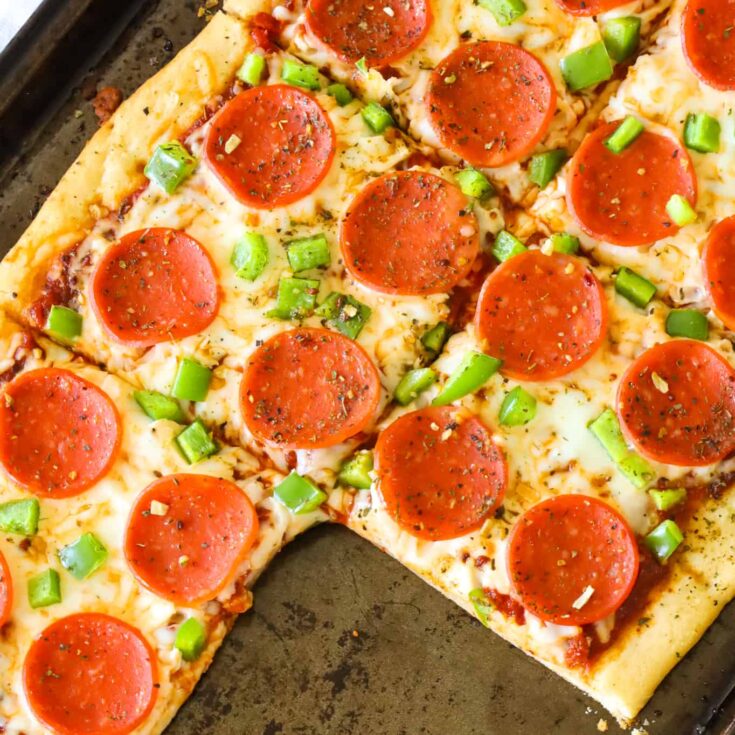 Crescent Roll Pizza is an easy weeknight dinner recipe using a can of Pillsbury crescent dough topped with pizza sauce, shredded mozzarella cheese, pepperoni and diced green peppers.