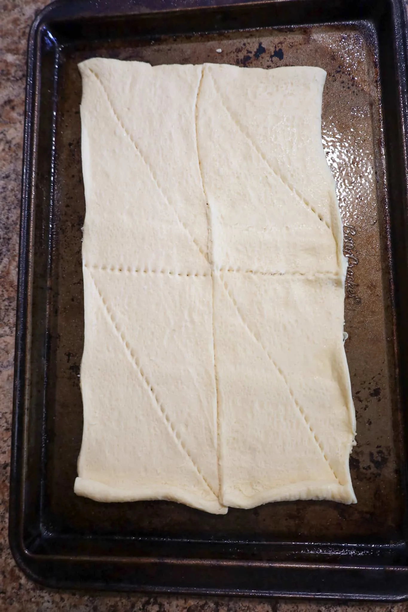 crescent dough on greased baking sheet