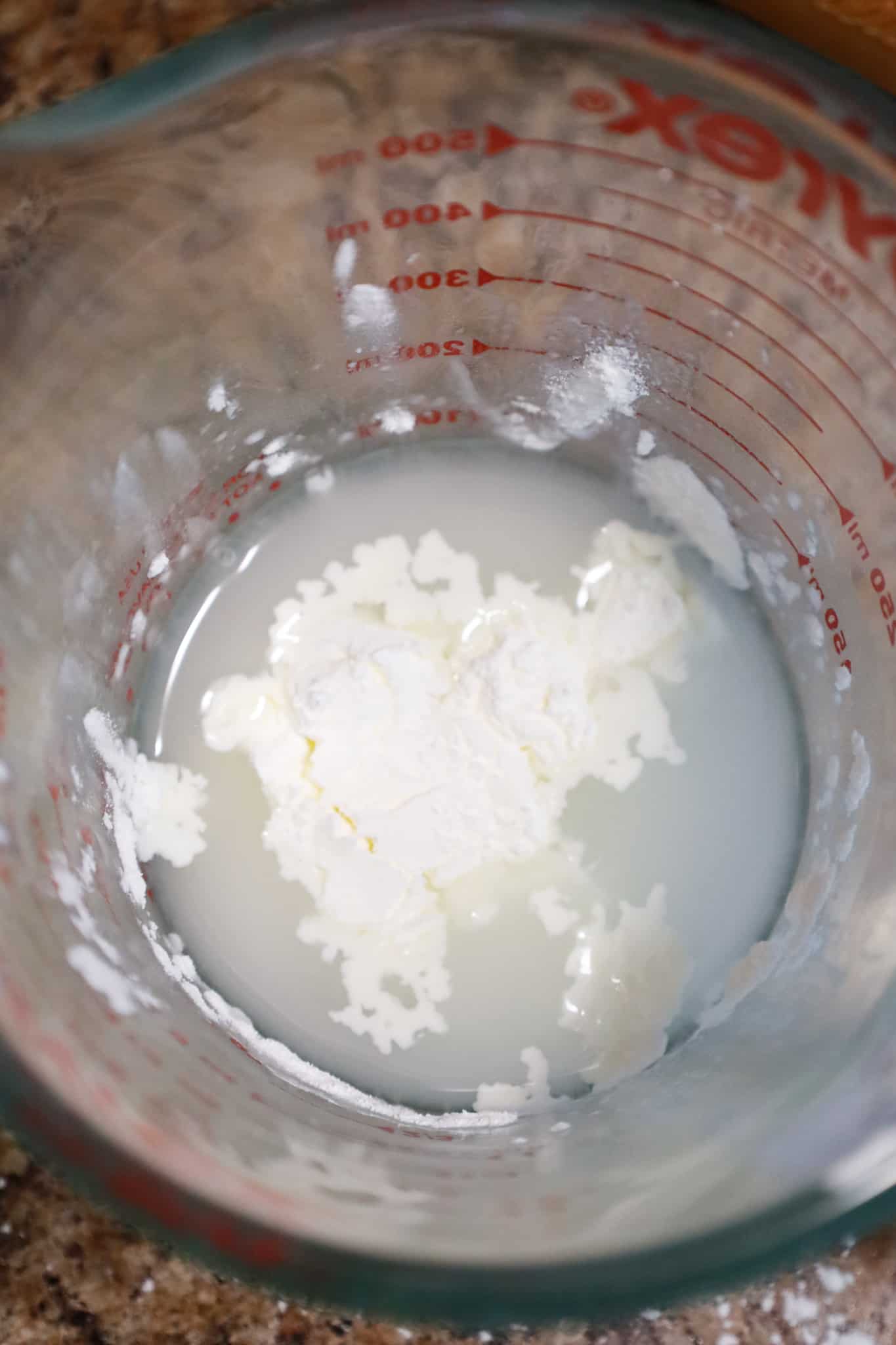 corn starch and water in a glass measuring cup