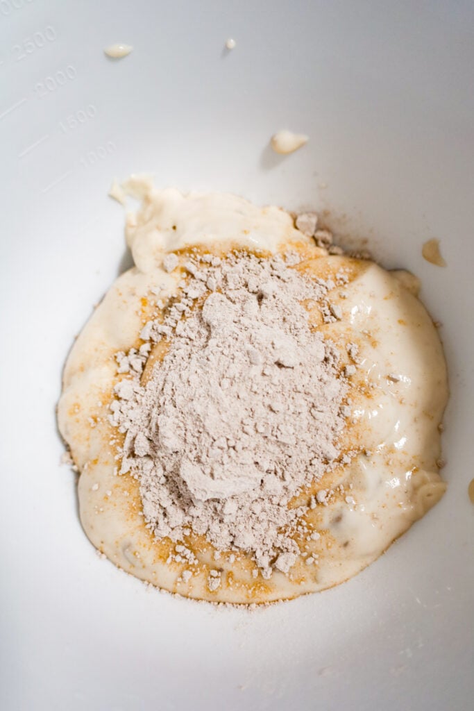 brown gravy mix on top of condensed cream of mushroom soup in a mixing bowl