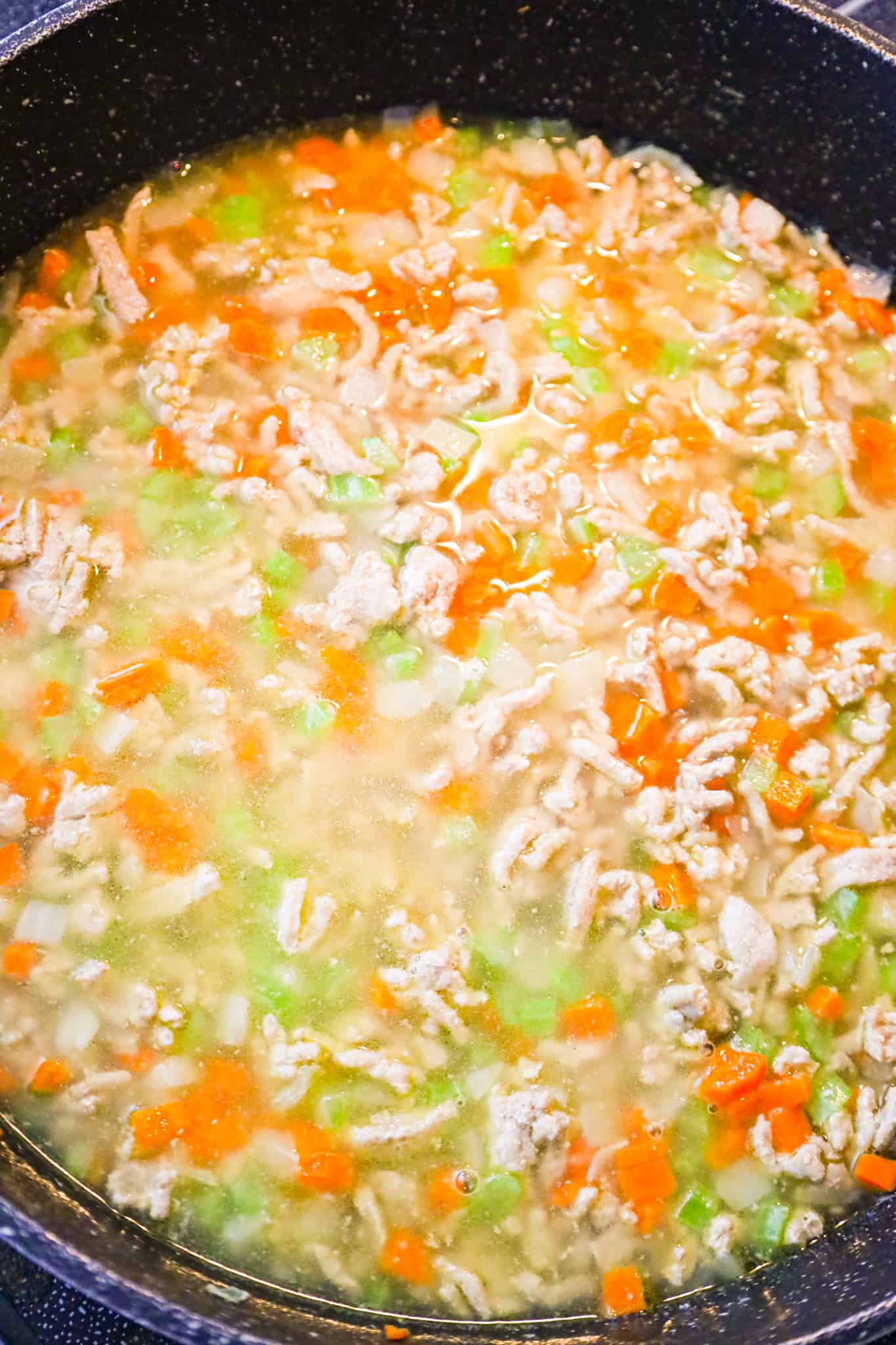chicken broth and rice added to ground turkey and diced veggies in skillet