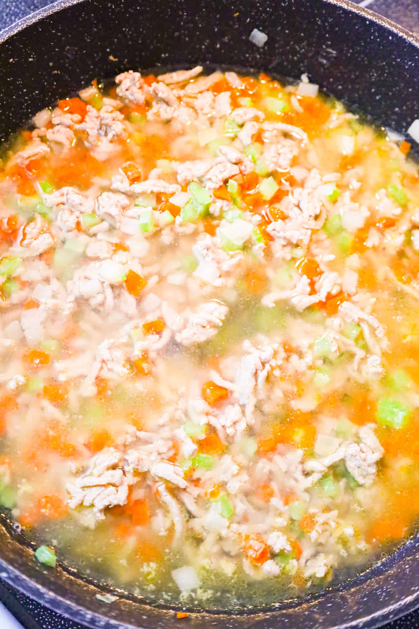 chicken broth added to skillet with ground turkey and diced veggies