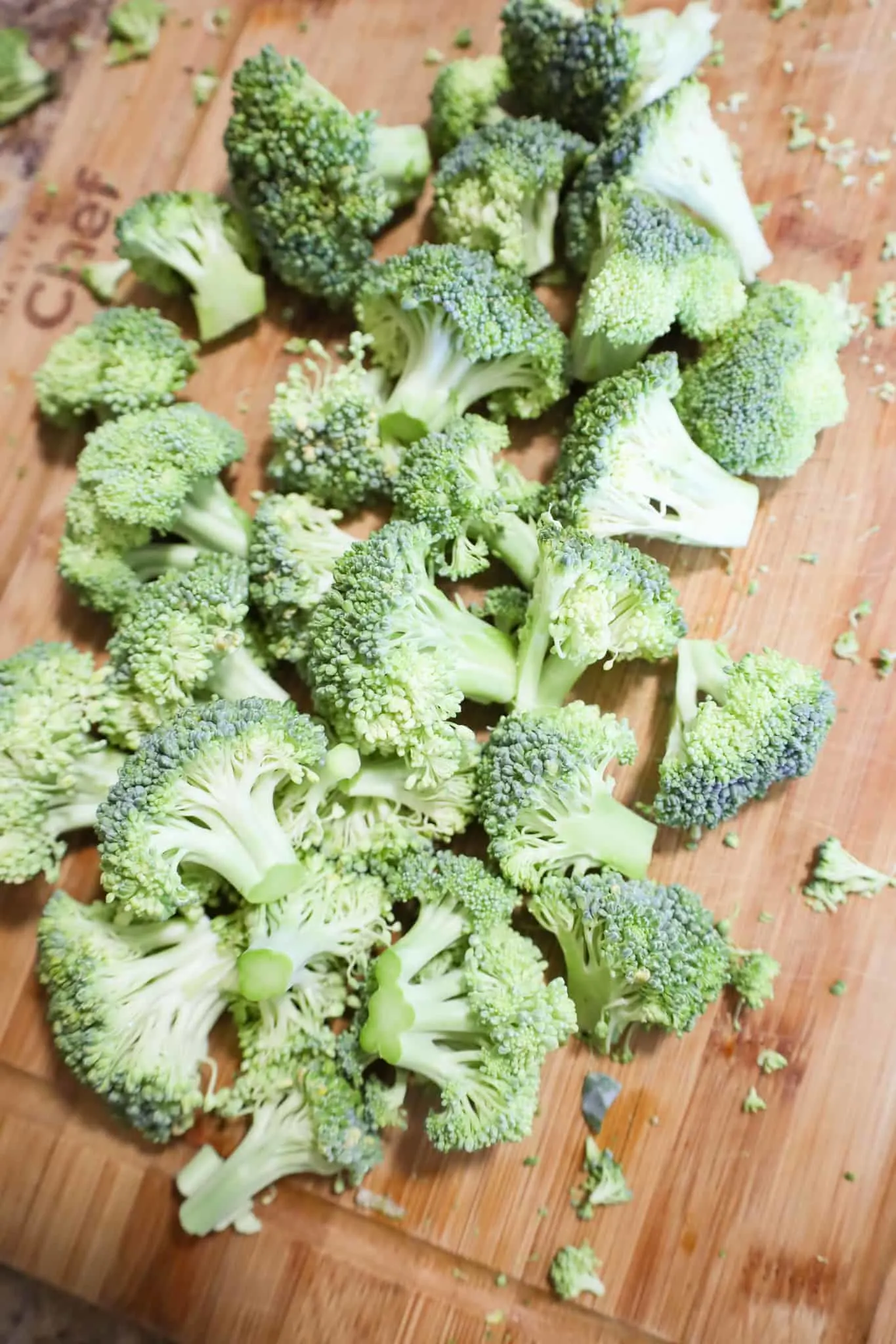 uncooked broccoli florets on a cutting board
