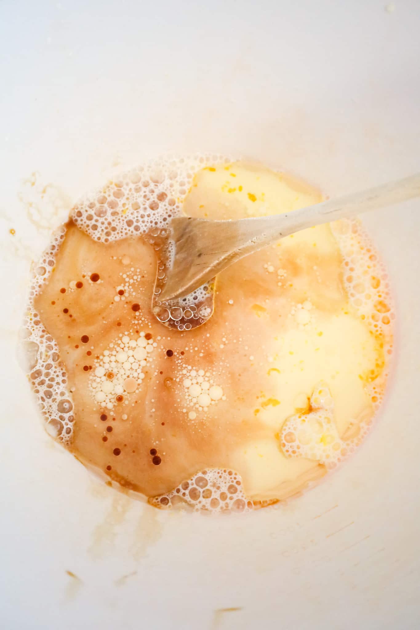 vanilla extract, milk, butter and egg mixture in a mixing bowl