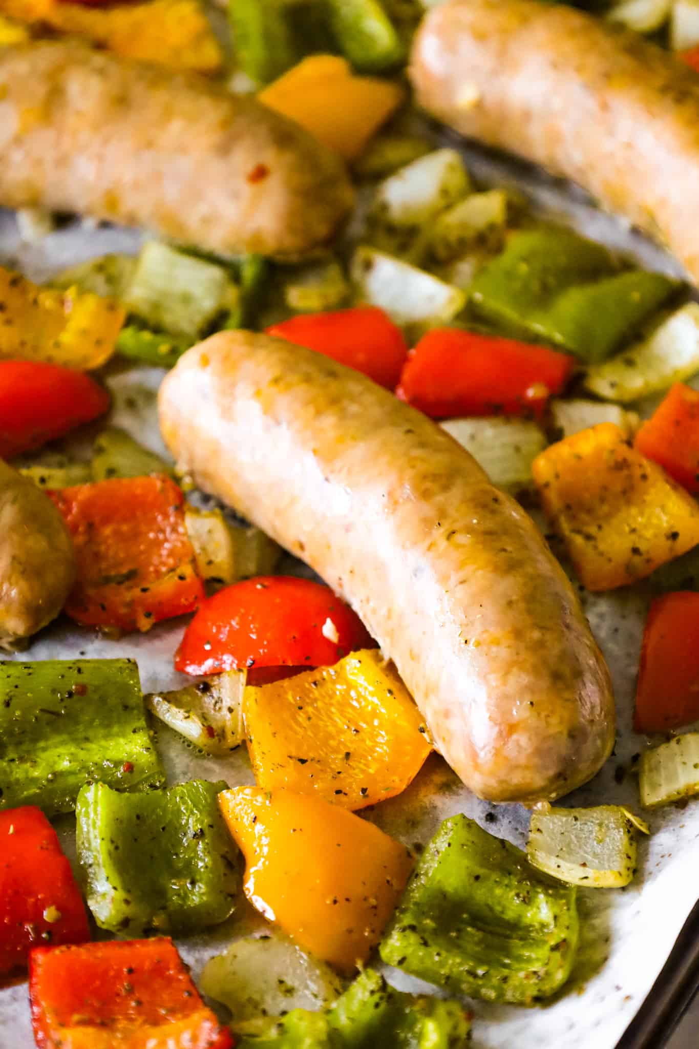 Oven Baked Italian Sausage is an easy sheet pan dinner with diced bell peppers and onions tossed in olive oil and Italian seasoning.