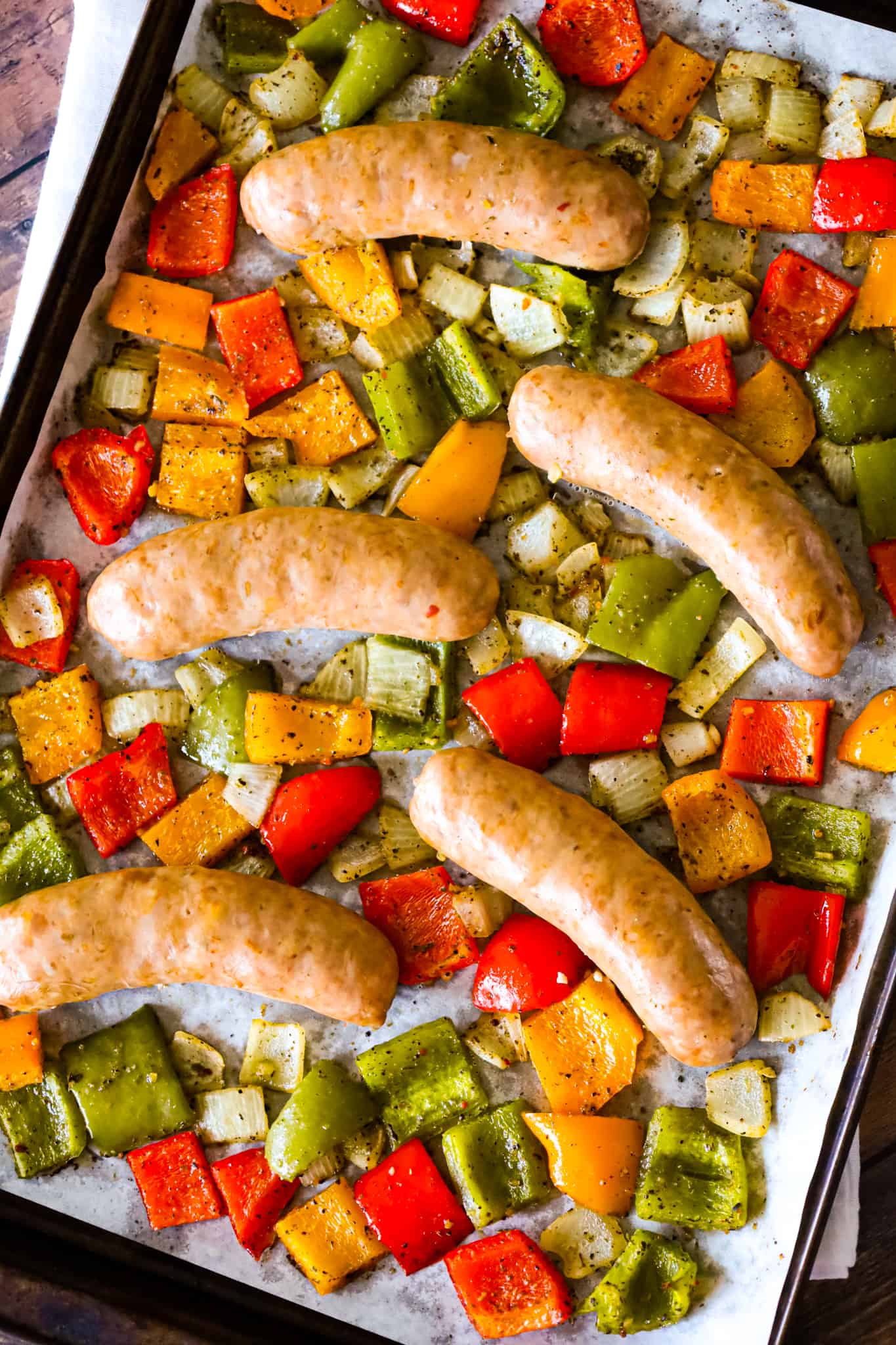 Oven Baked Italian Sausage is an easy sheet pan dinner with diced bell peppers and onions tossed in olive oil and Italian seasoning.