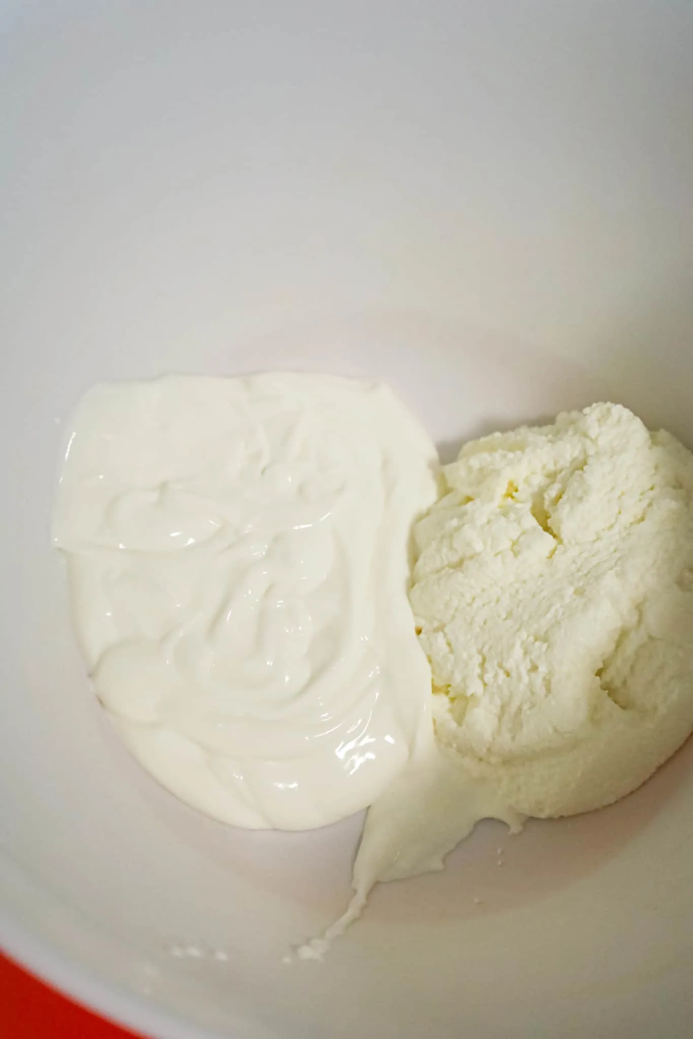 sour cream and ricotta cheese in a mixing bowl