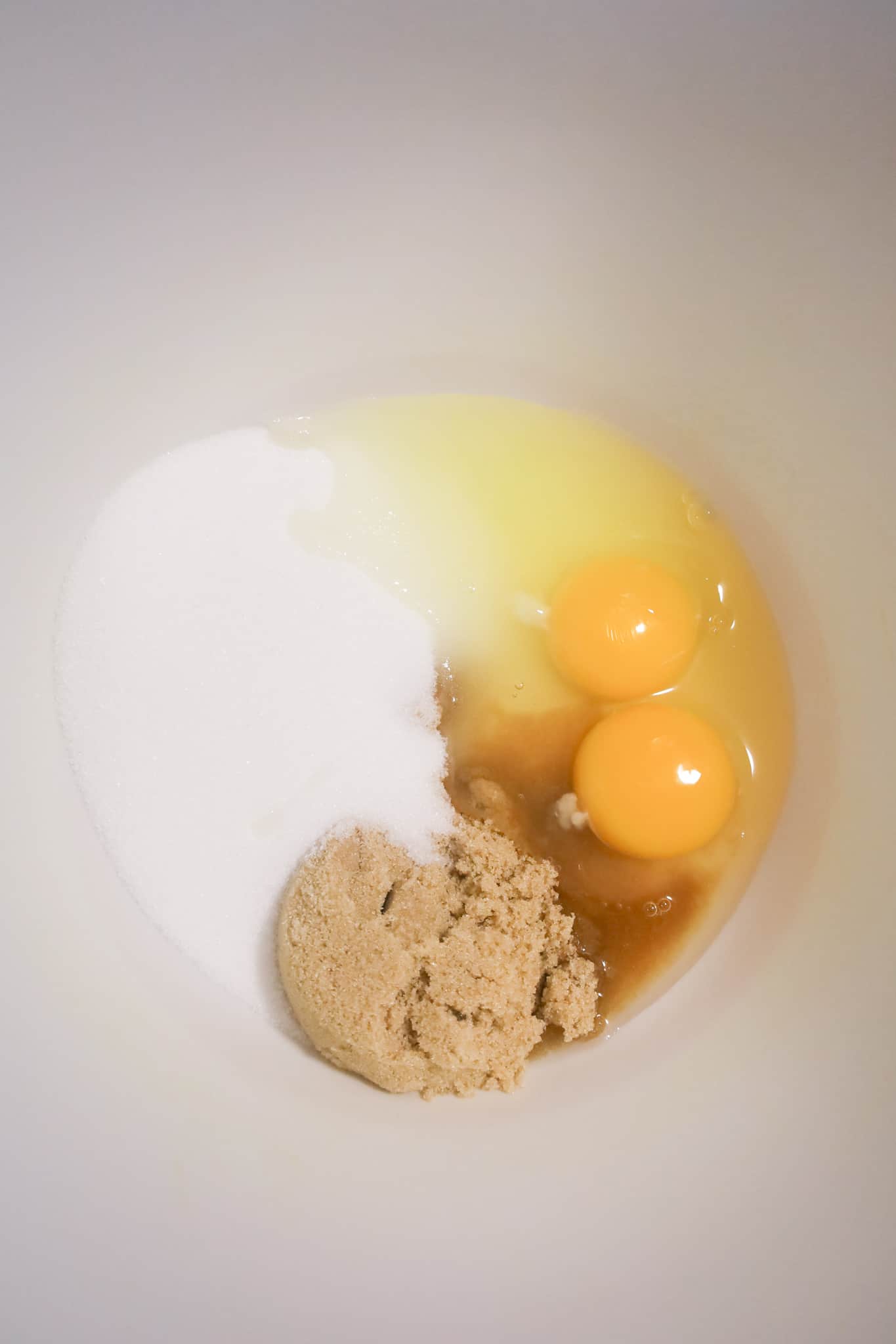 brown sugar, white sugar, vanilla extract and eggs in a mixing bowl