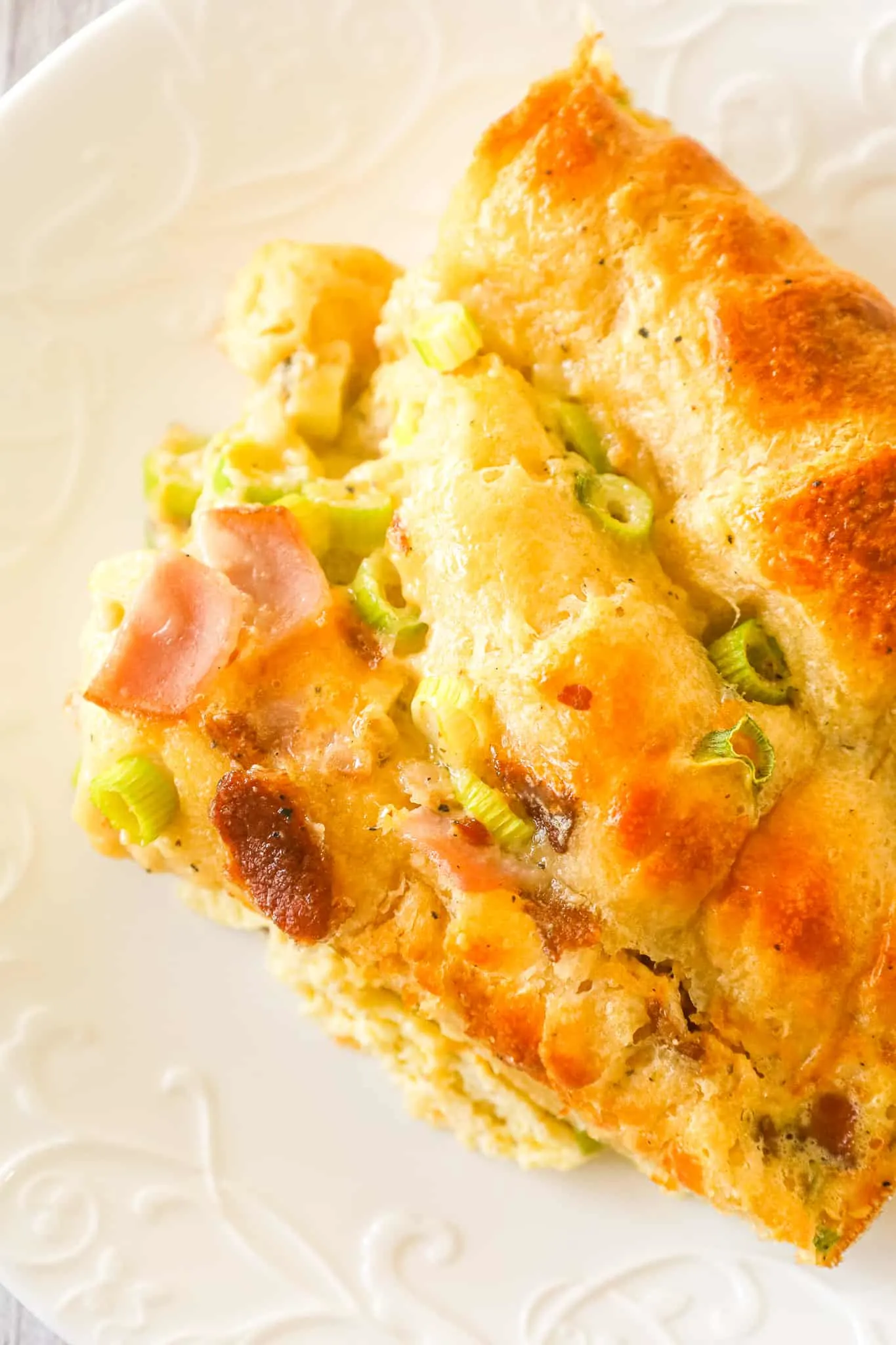 Crescent Roll Breakfast Casserole is a tasty egg casserole made with Pillsbury crescent roll dough and loaded with crumbled bacon, chopped ham, green onions and shredded cheese.