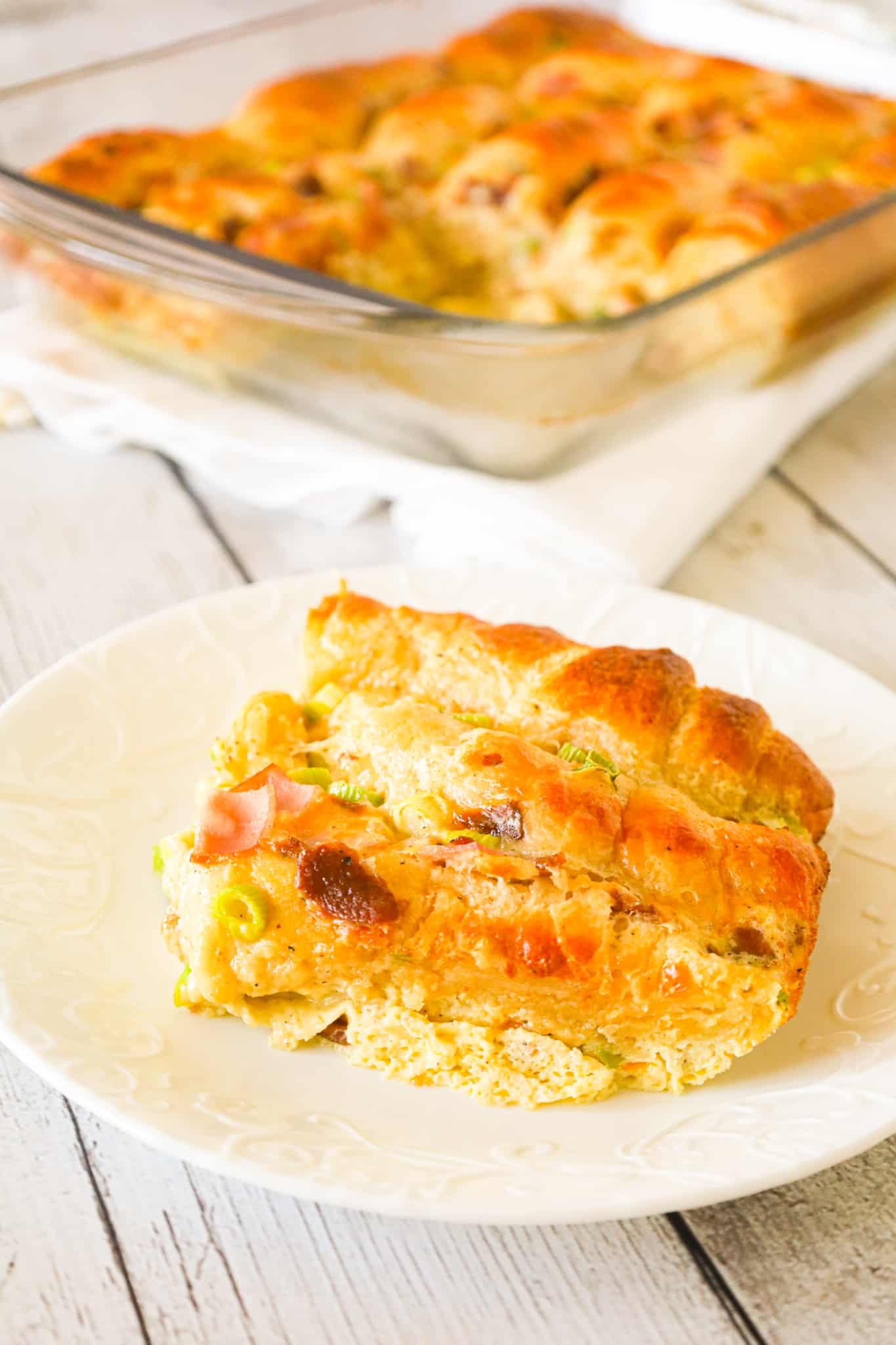Crescent Roll Breakfast Casserole is a tasty egg casserole made with Pillsbury crescent roll dough and loaded with crumbled bacon, chopped ham, green onions and shredded cheese.
