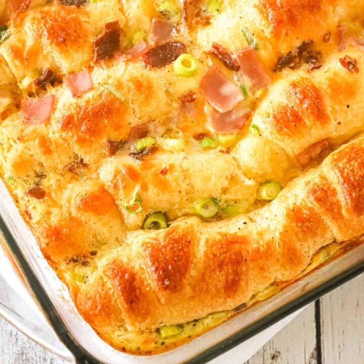 Crescent Roll Breakfast Casserole is a tasty egg casserole made with Pillsbury crescent roll dough and loaded with crumbled bacon, chopped ham, green onions and shredded cheese.