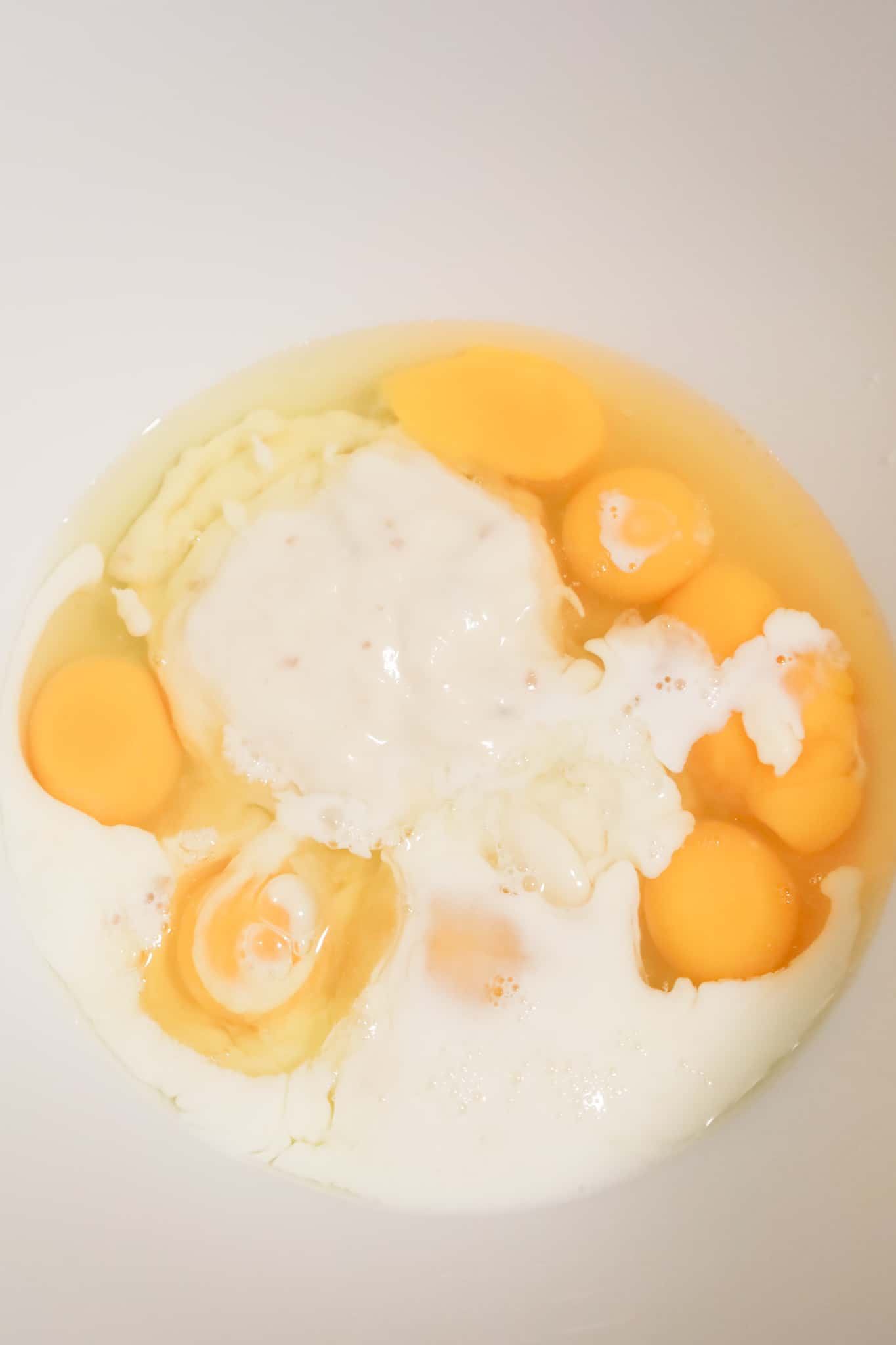 condensed cream of bacon soup, milk and eggs in a large mixing bowl
