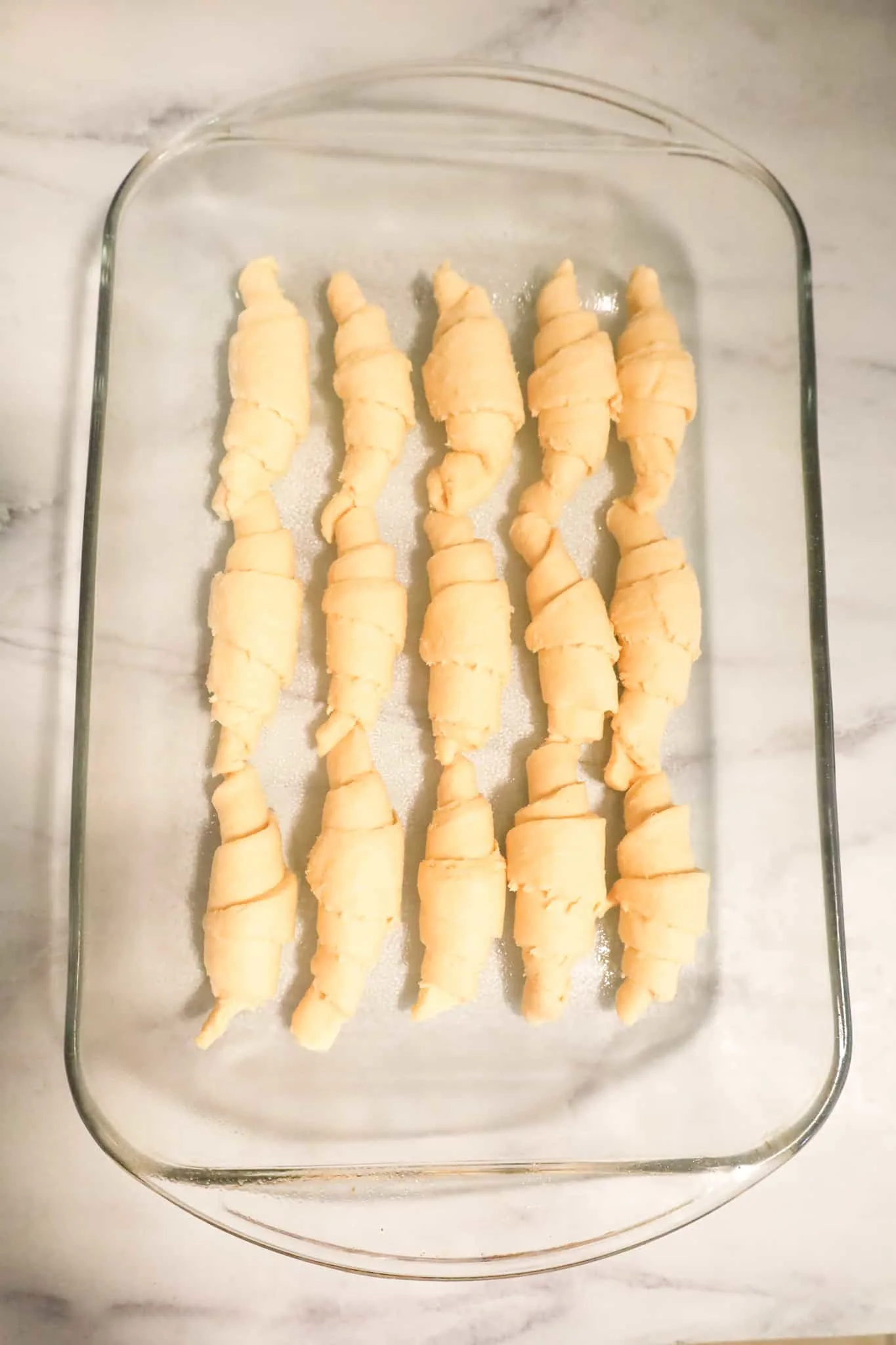 raw crescent rolls in a baking dish