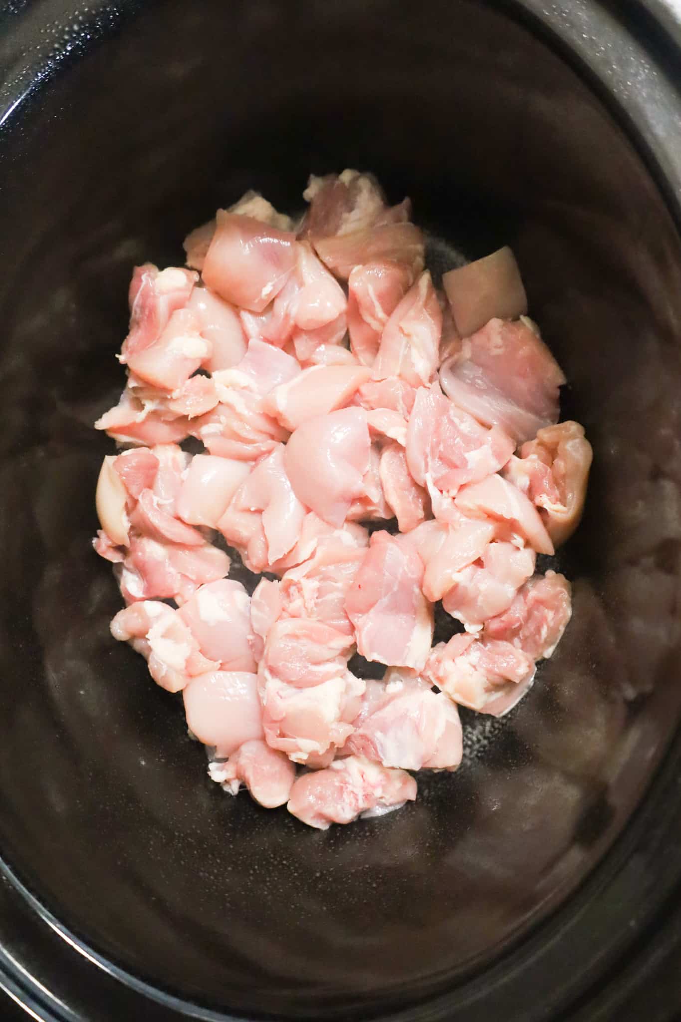chicken thigh chunks in the bottom of a crock pot