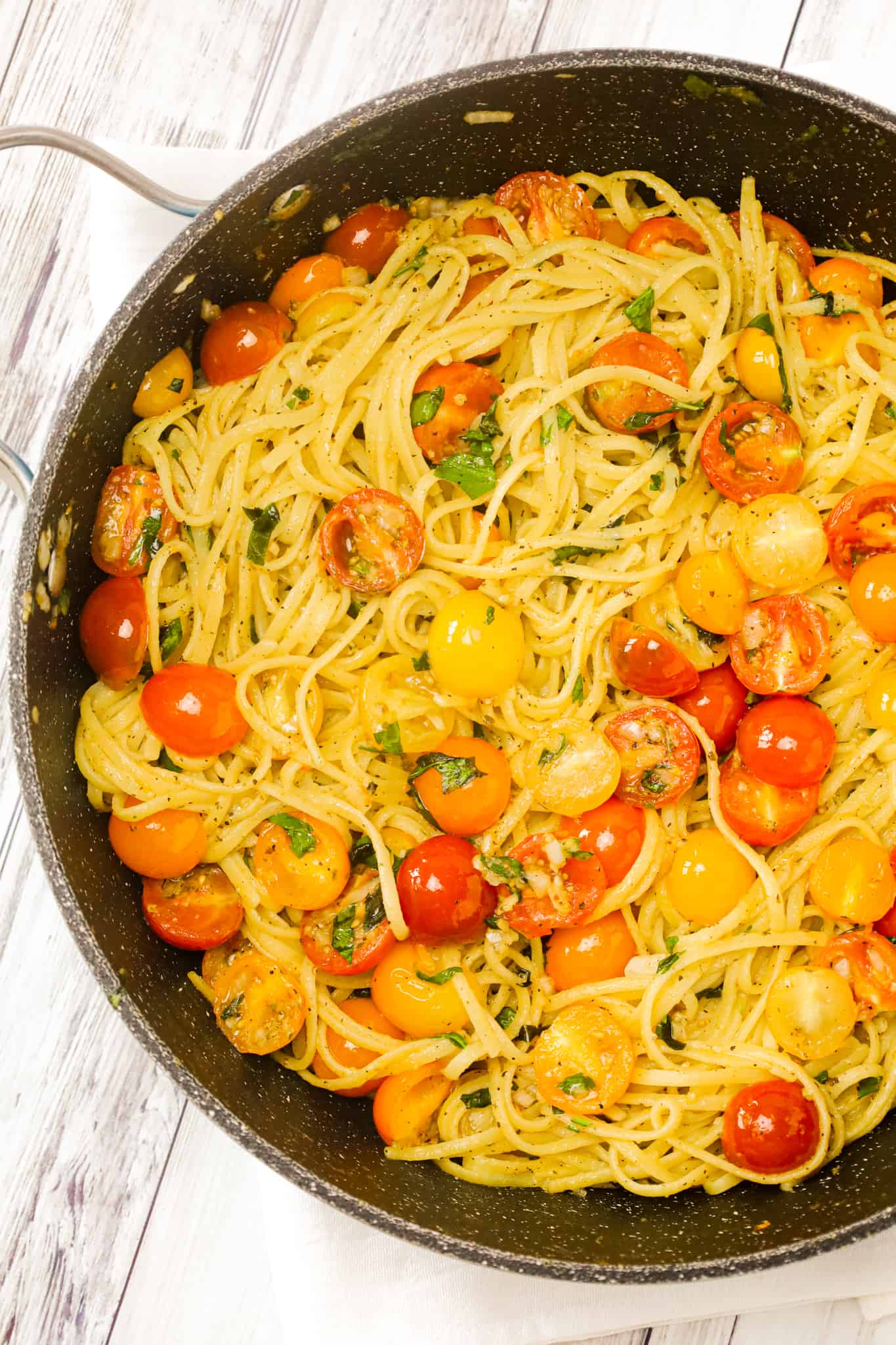 Linguine Positano is a delicious pasta dish loaded with fresh cherry tomatoes, onions, basil, parsley and garlic puree all tossed in olive oil.