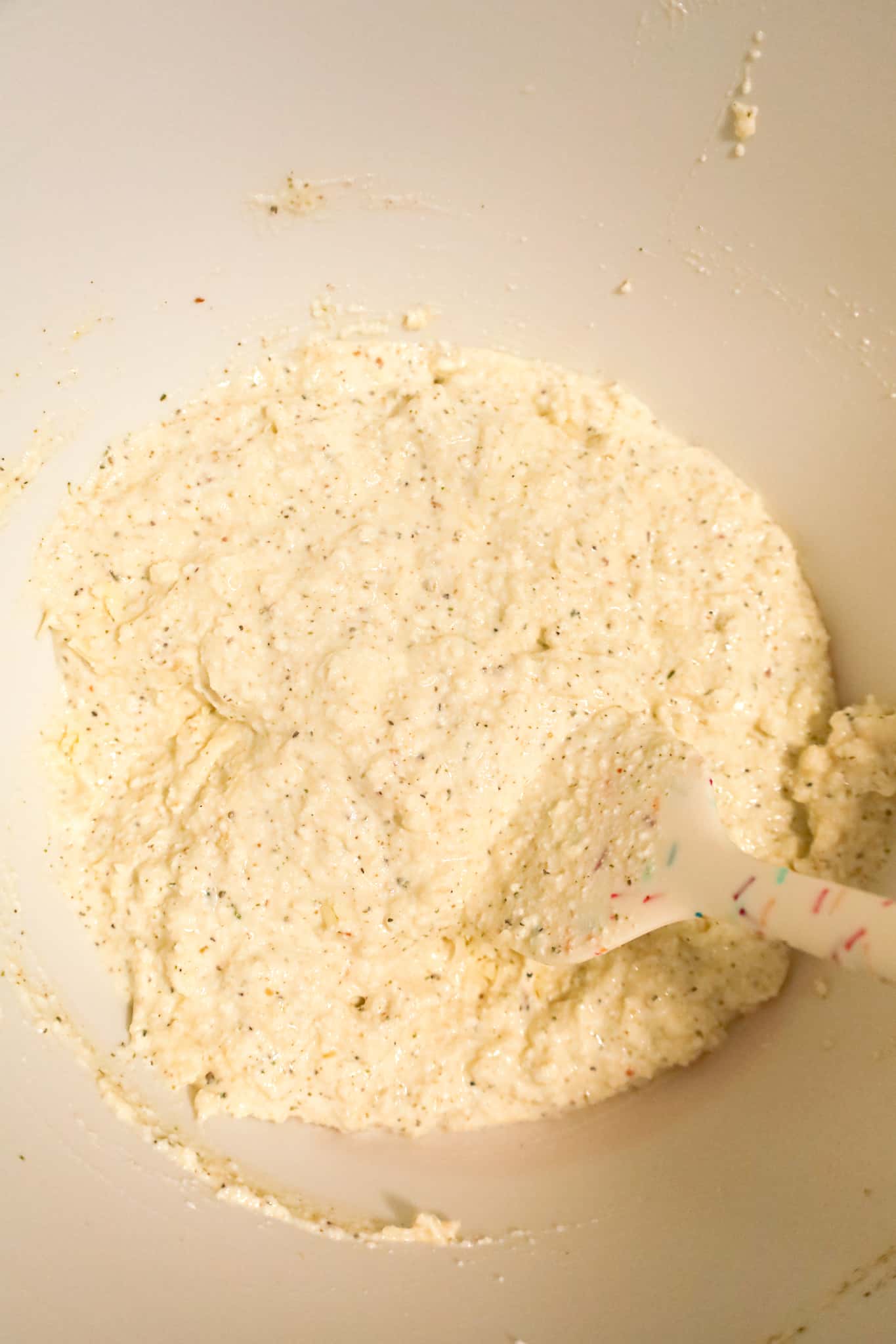shredded cheese and ricotta mixture in a mixing bowl