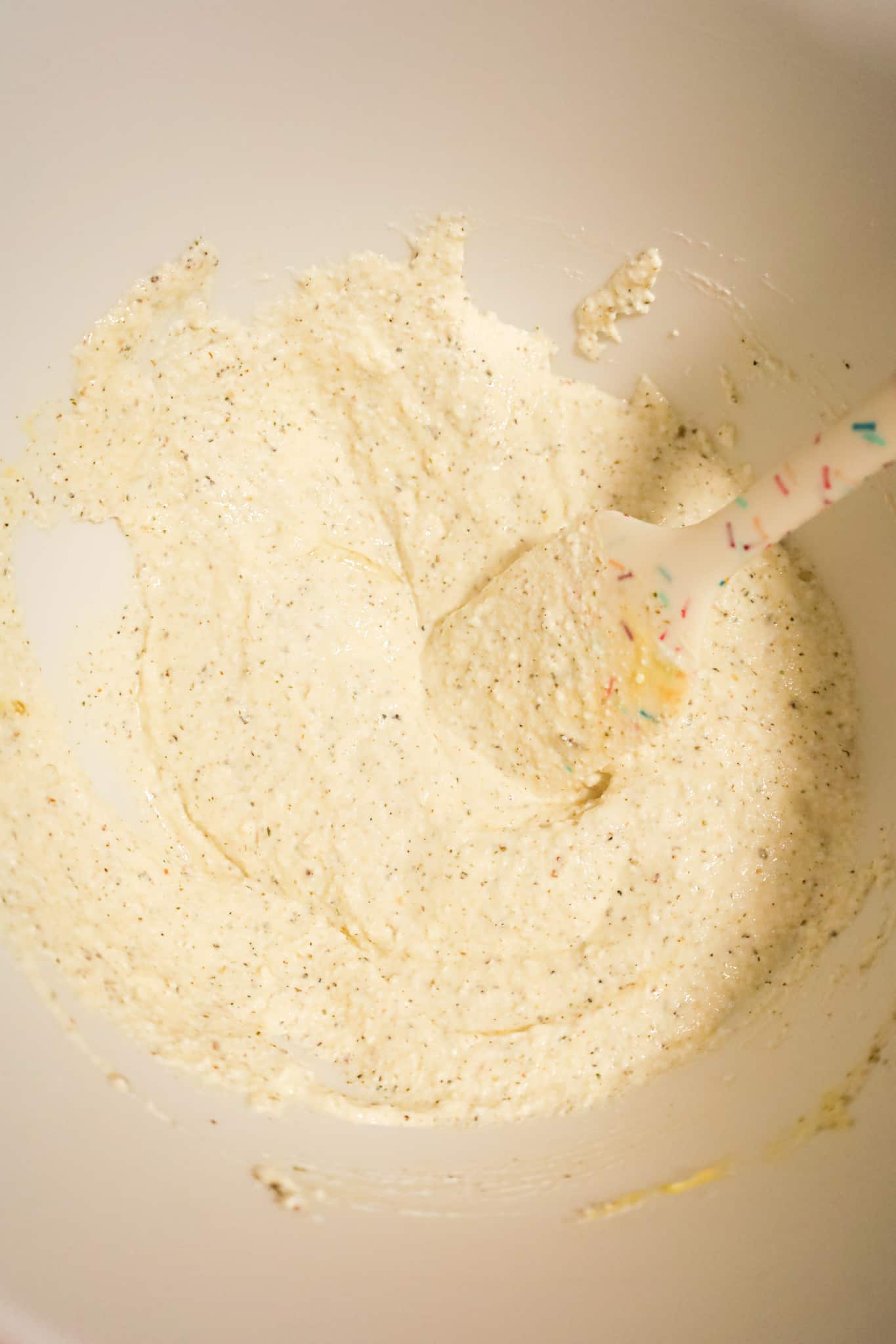 ricotta, sour cream and seasoning mixture in a mixing bowl