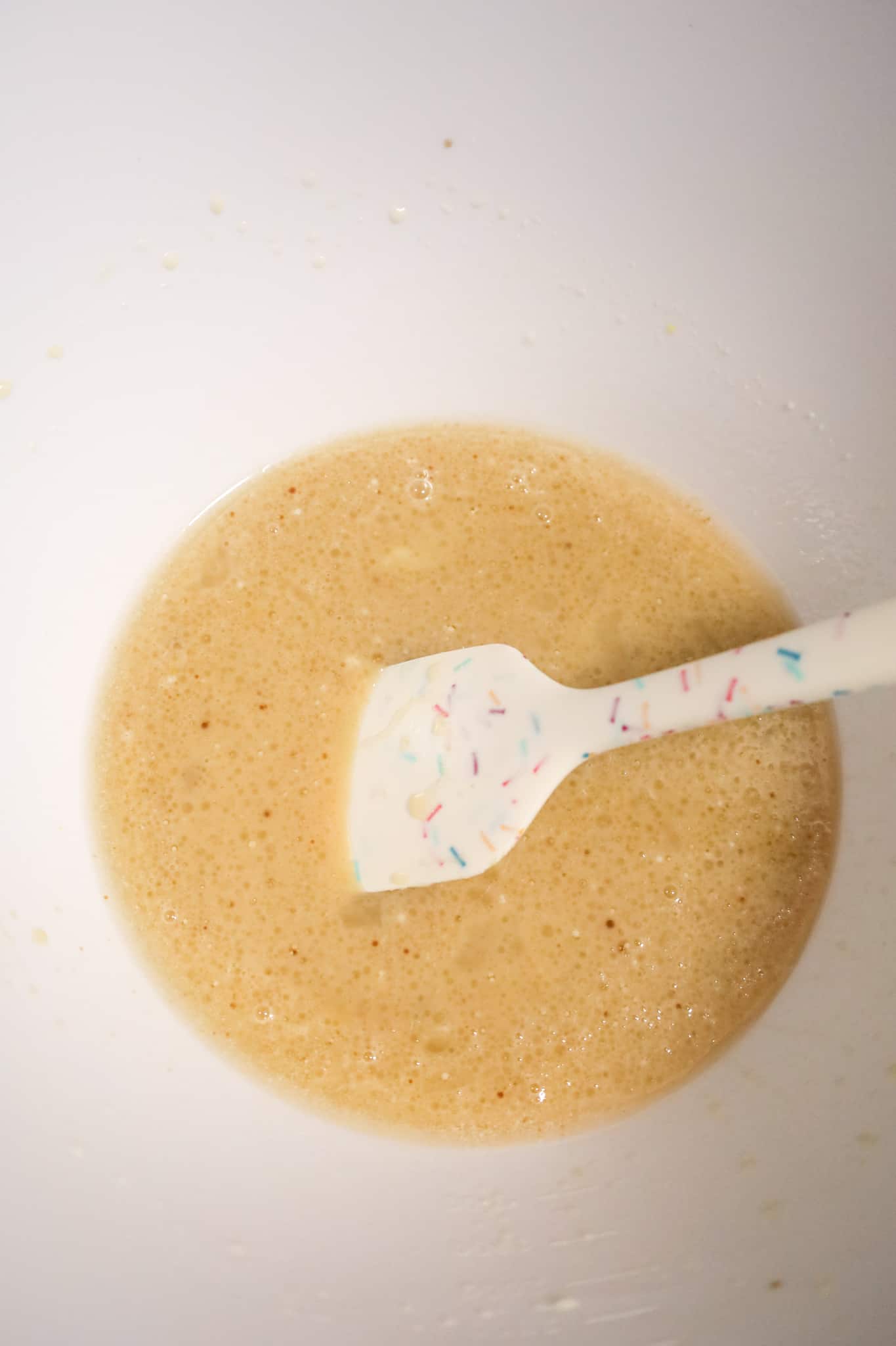 sugar, oil, vanilla, milk and egg mixture in a mixing bowl