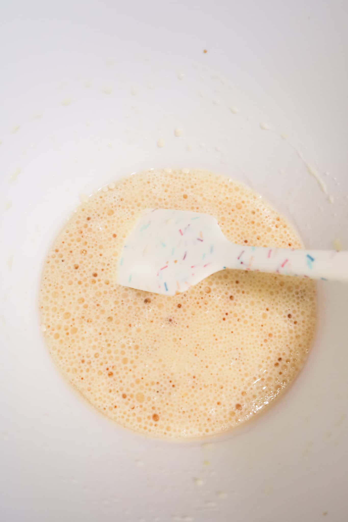 oil, vanilla, milk and egg mixture in a mixing bowl