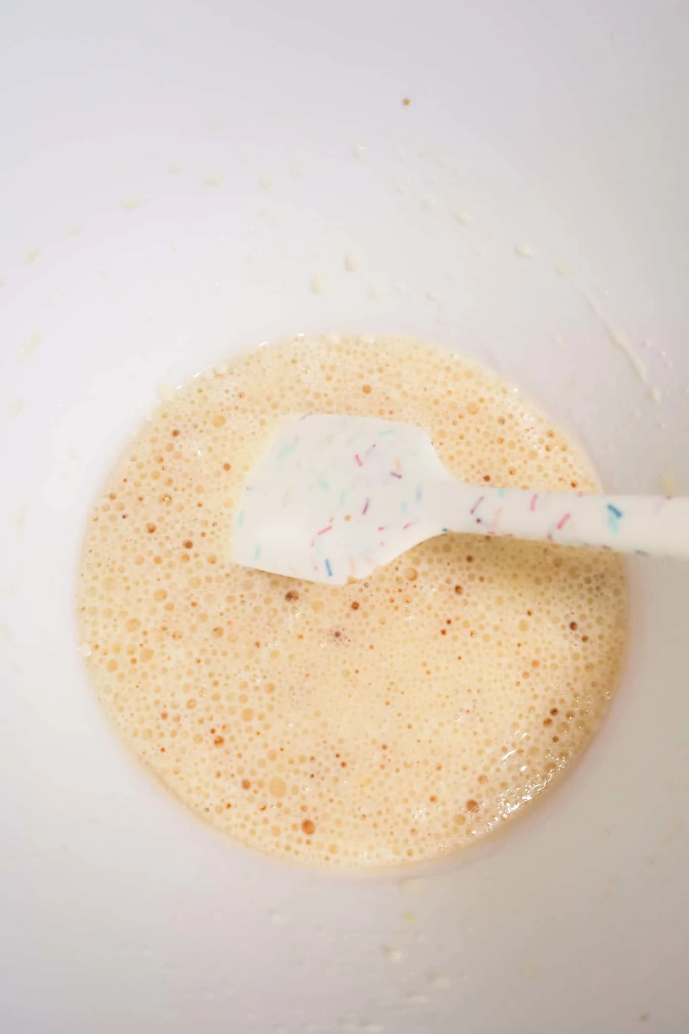oil, vanilla, milk and egg mixture in a mixing bowl