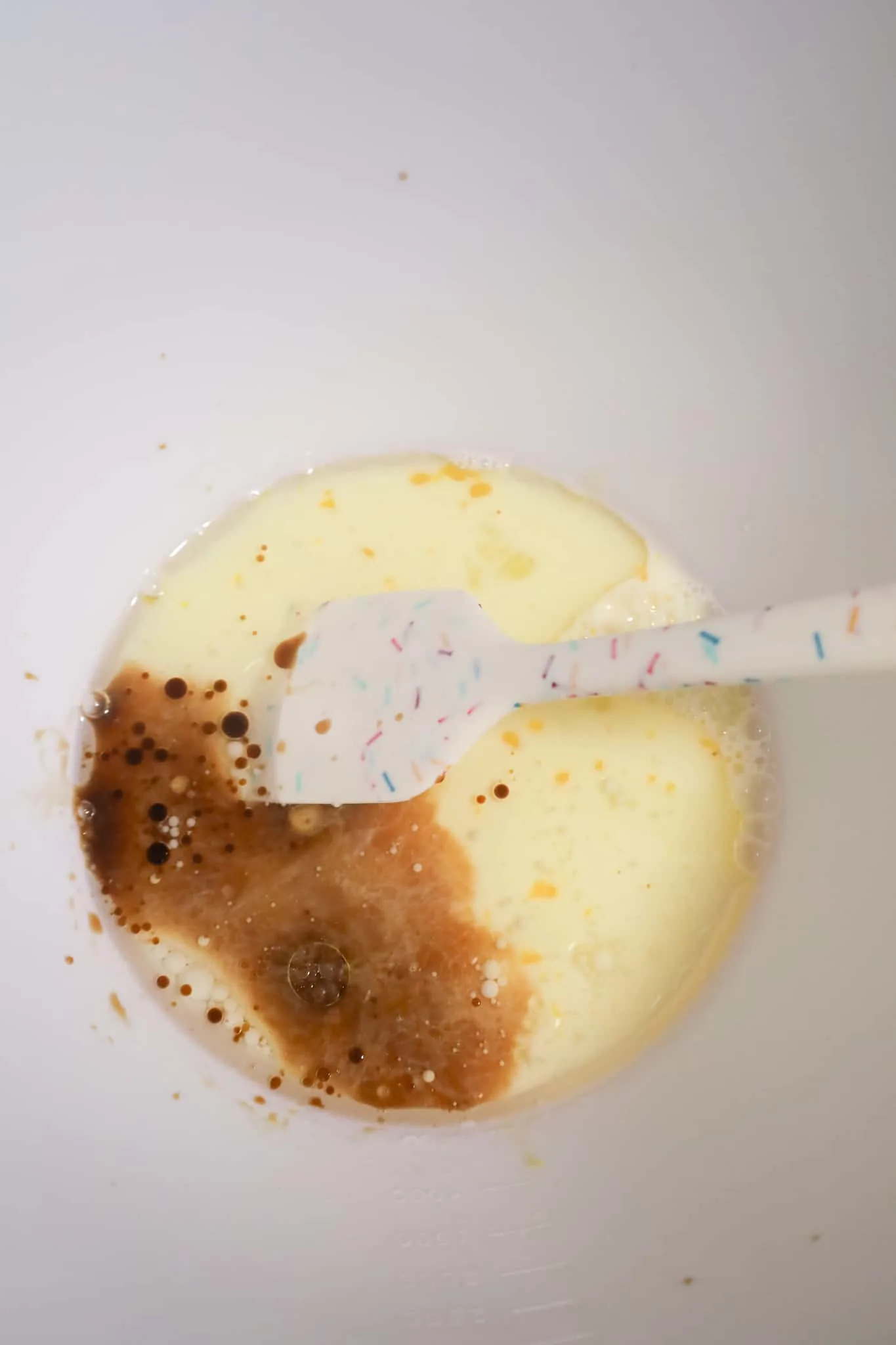 vanilla extract, oil, milk and egg in a mixing bowl
