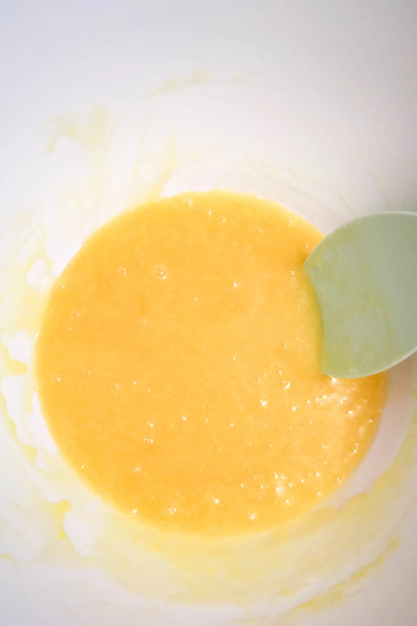 corn syrup, sugar, vanilla and melted butter mixture in a mixing bowl