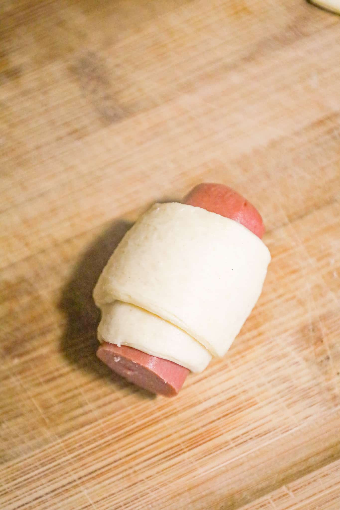 hot dog piece wrapped in crescent dough