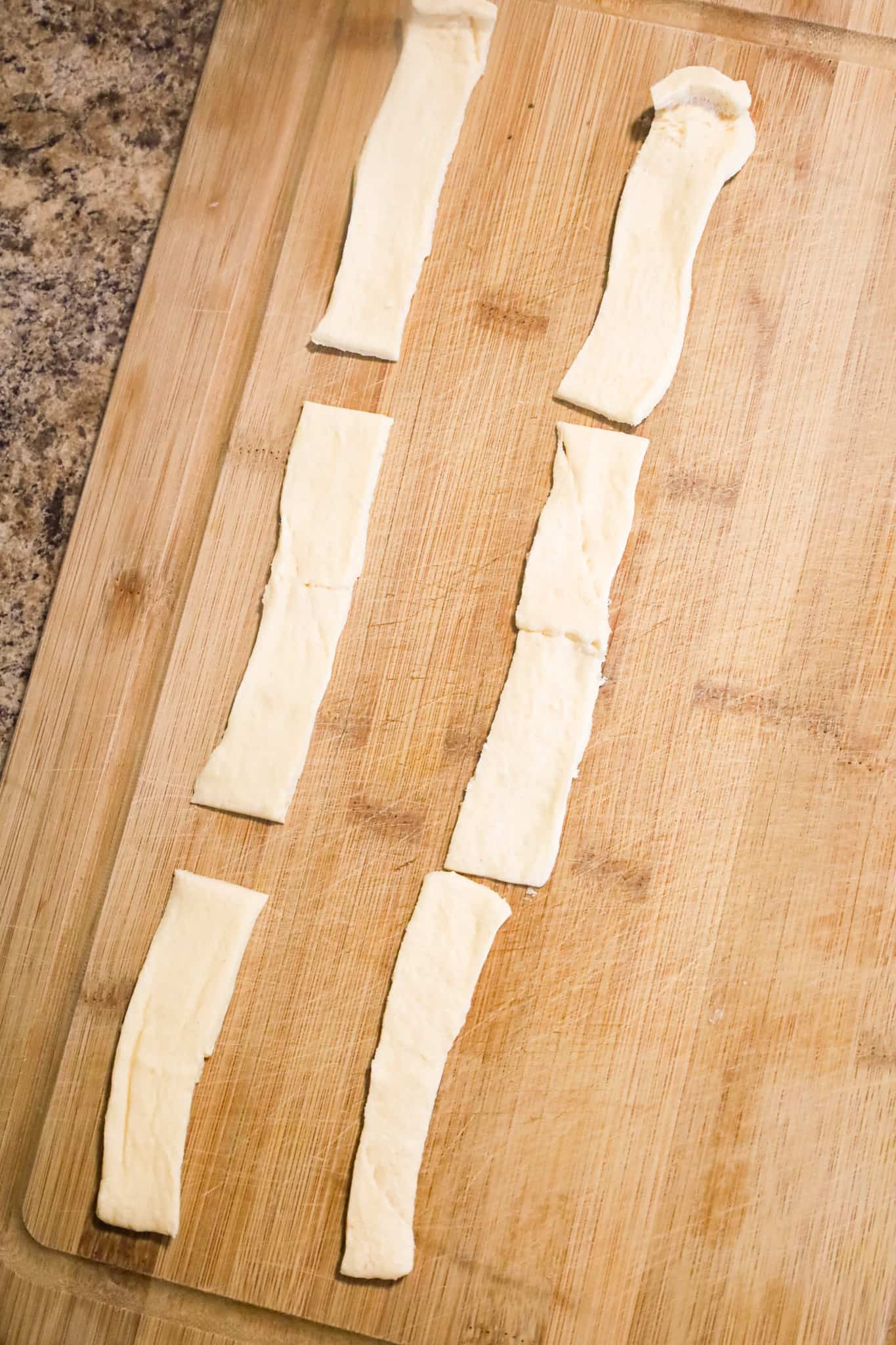 strips of crescent dough on a cutting board