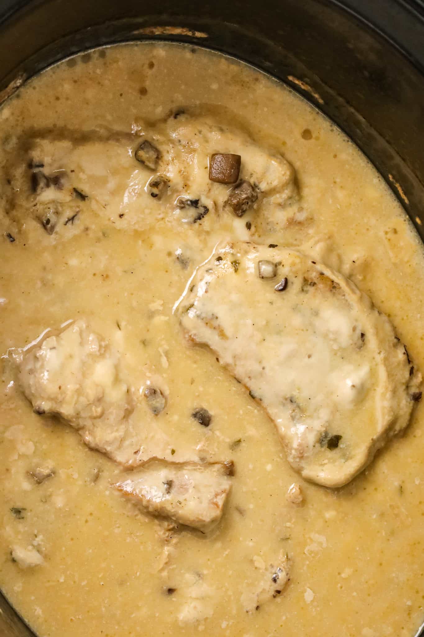  3 Ingredient Crock Pot Pork Chops are an easy slow cooker dinner recipe made with condensed cream of mushroom soup and ranch dressing mix.