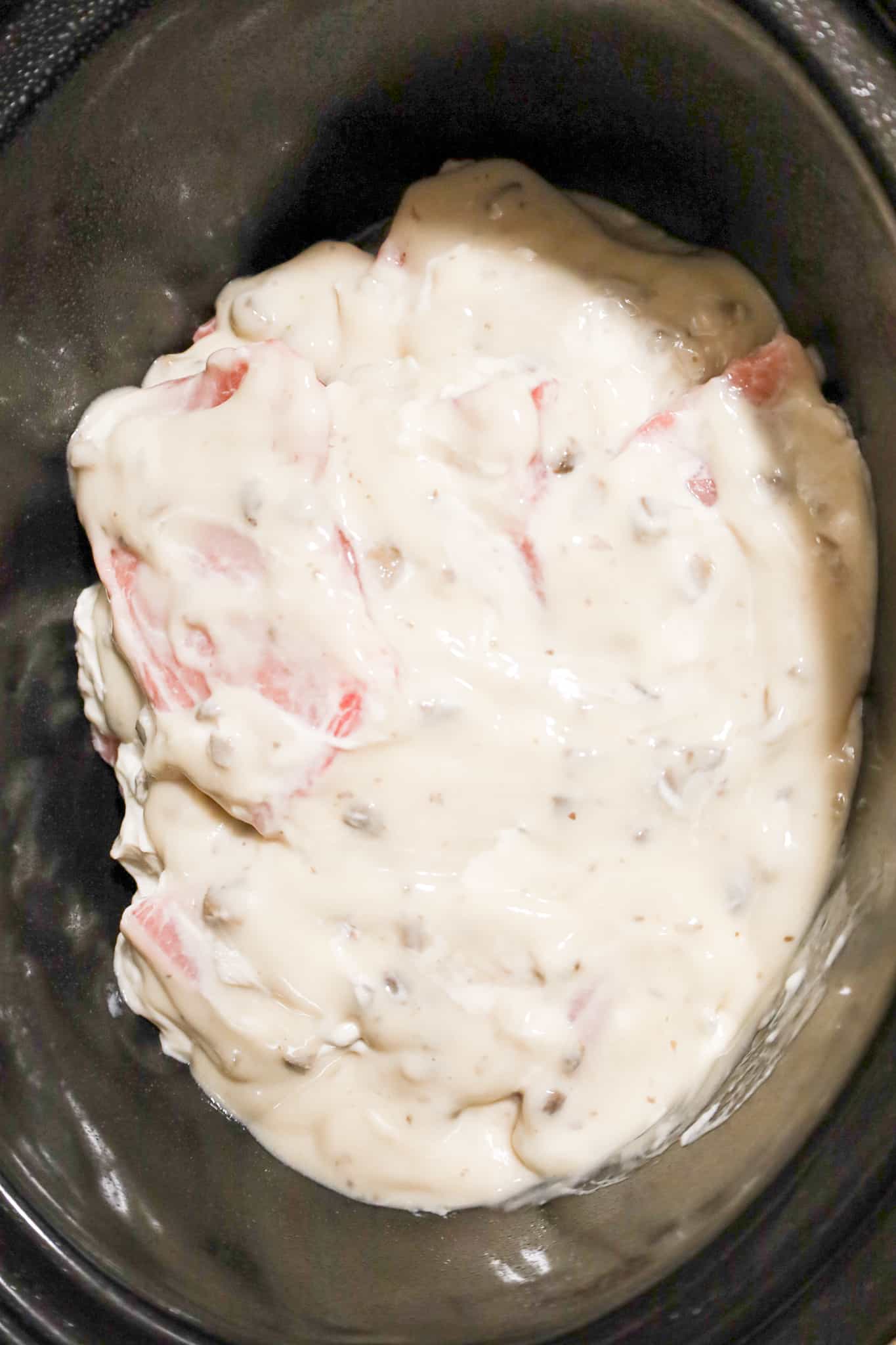 condensed cream of mushroom soup on top of raw pork chops in a crock pot