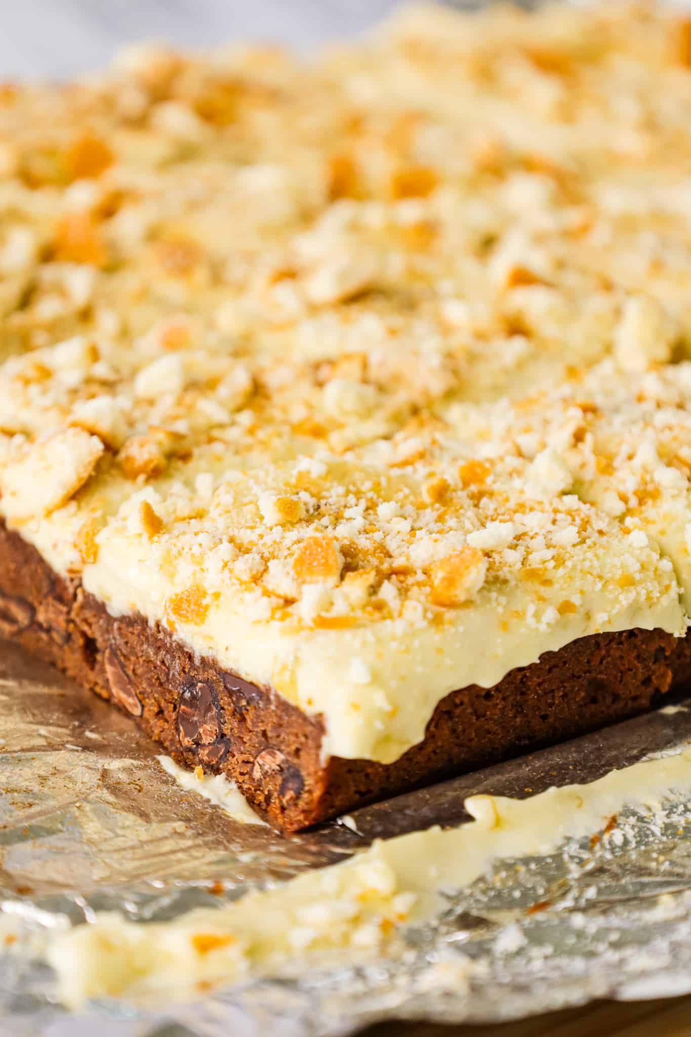 Banana Pudding Brownies are a decadent dessert with a fudgy chocolate brownie base topped with a banana pudding and Cool Whip mixture, sliced bananas and crumbled vanilla wafer cookies.