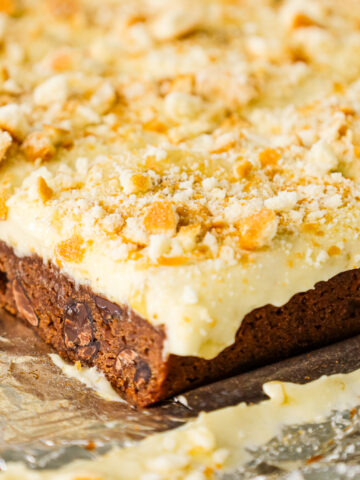 Banana Pudding Brownies are a decadent dessert with a fudgy chocolate brownie base topped with a banana pudding and Cool Whip mixture, sliced bananas and crumbled vanilla wafer cookies.