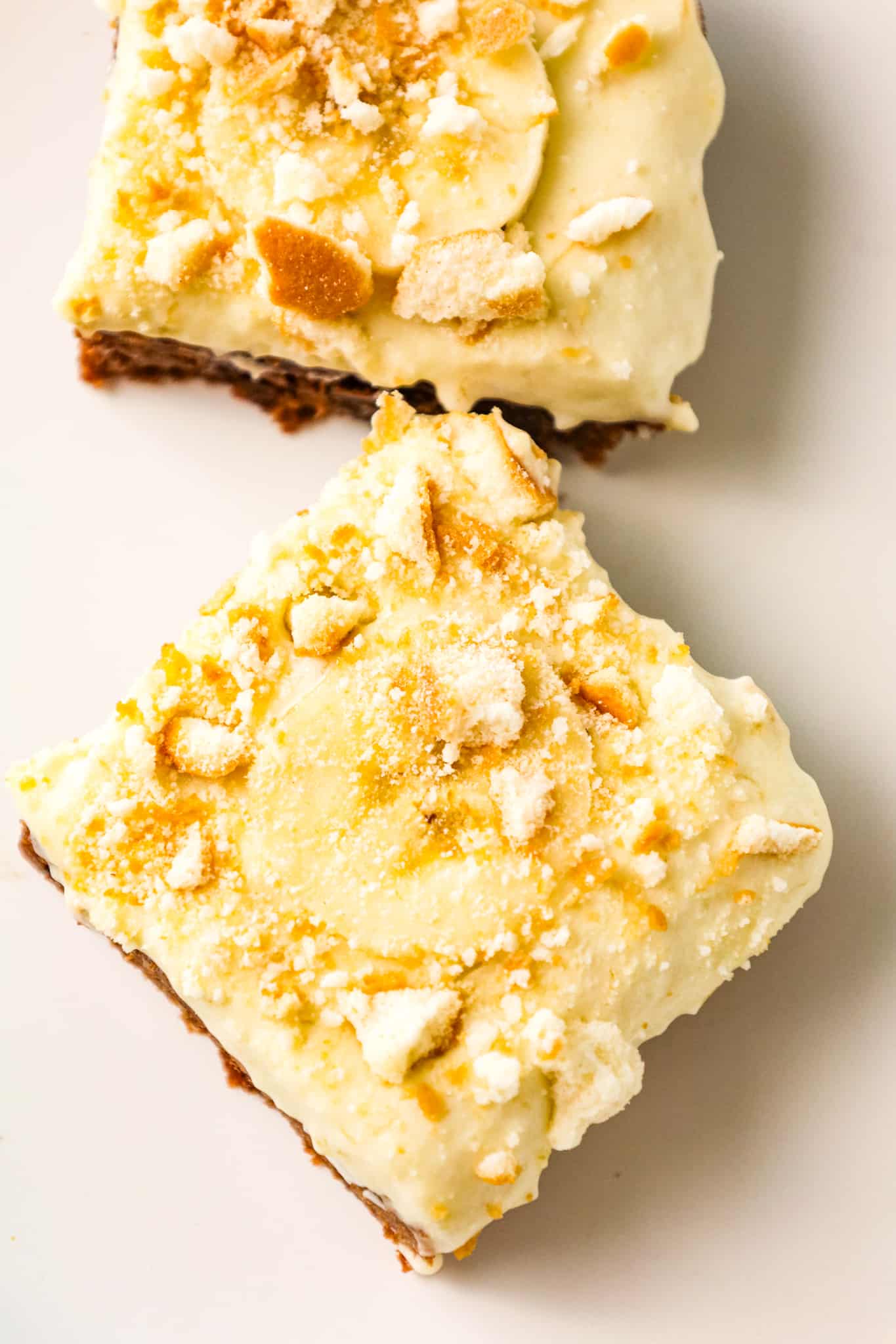 Banana Pudding Brownies are a decadent dessert with a fudgy chocolate brownie base topped with a banana pudding and Cool Whip mixture, sliced bananas and crumbled vanilla wafer cookies.
