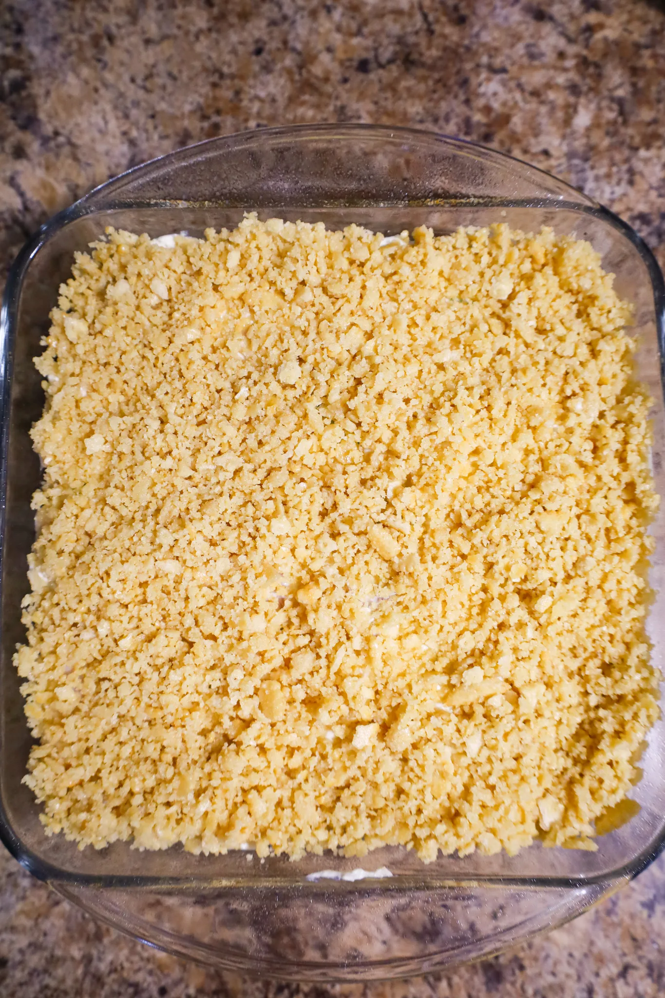ritz cracker crumbs on top of chicken casserole in a baking dish