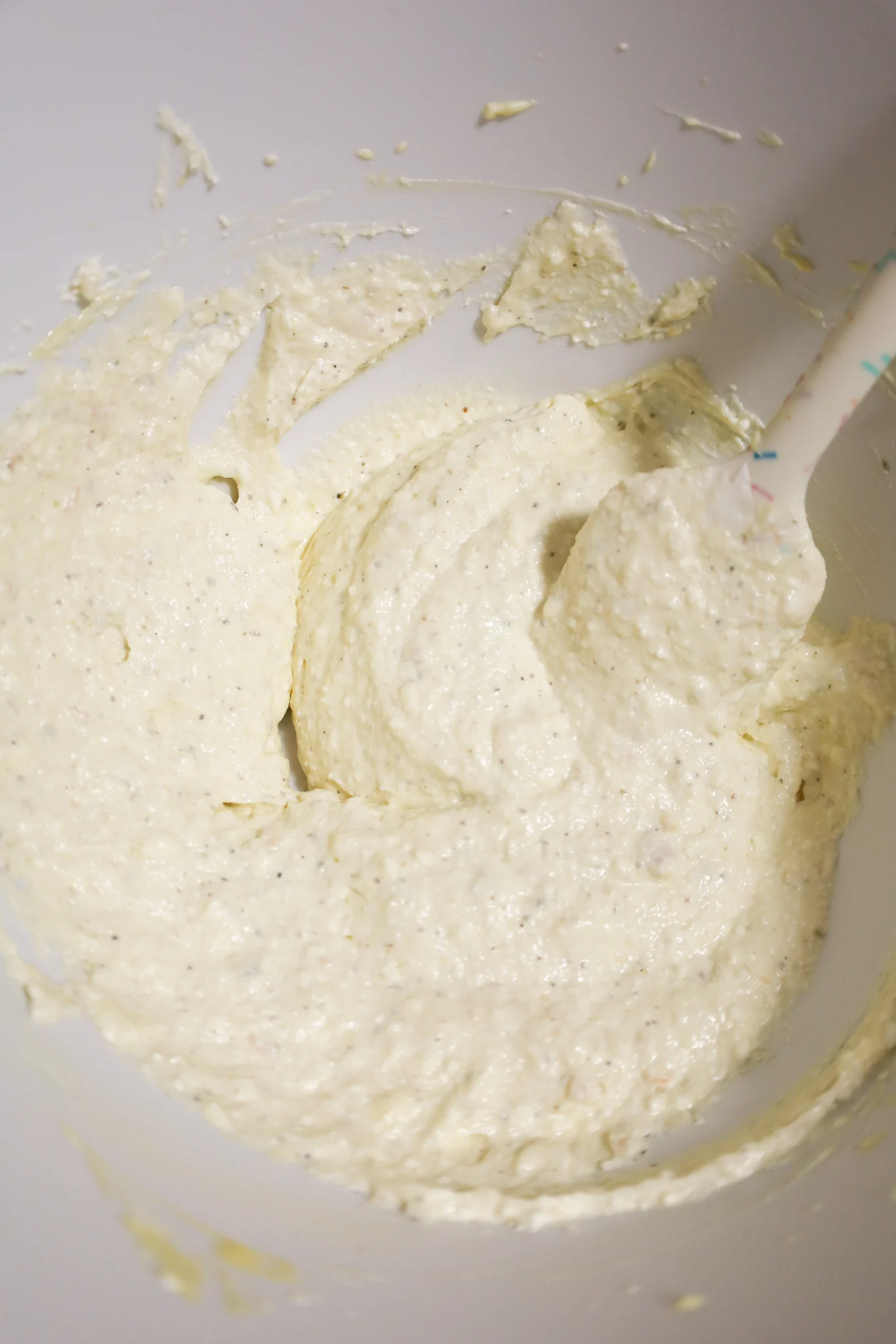 ricotta, sour cream and cream cheese mixture in a mixing bowl