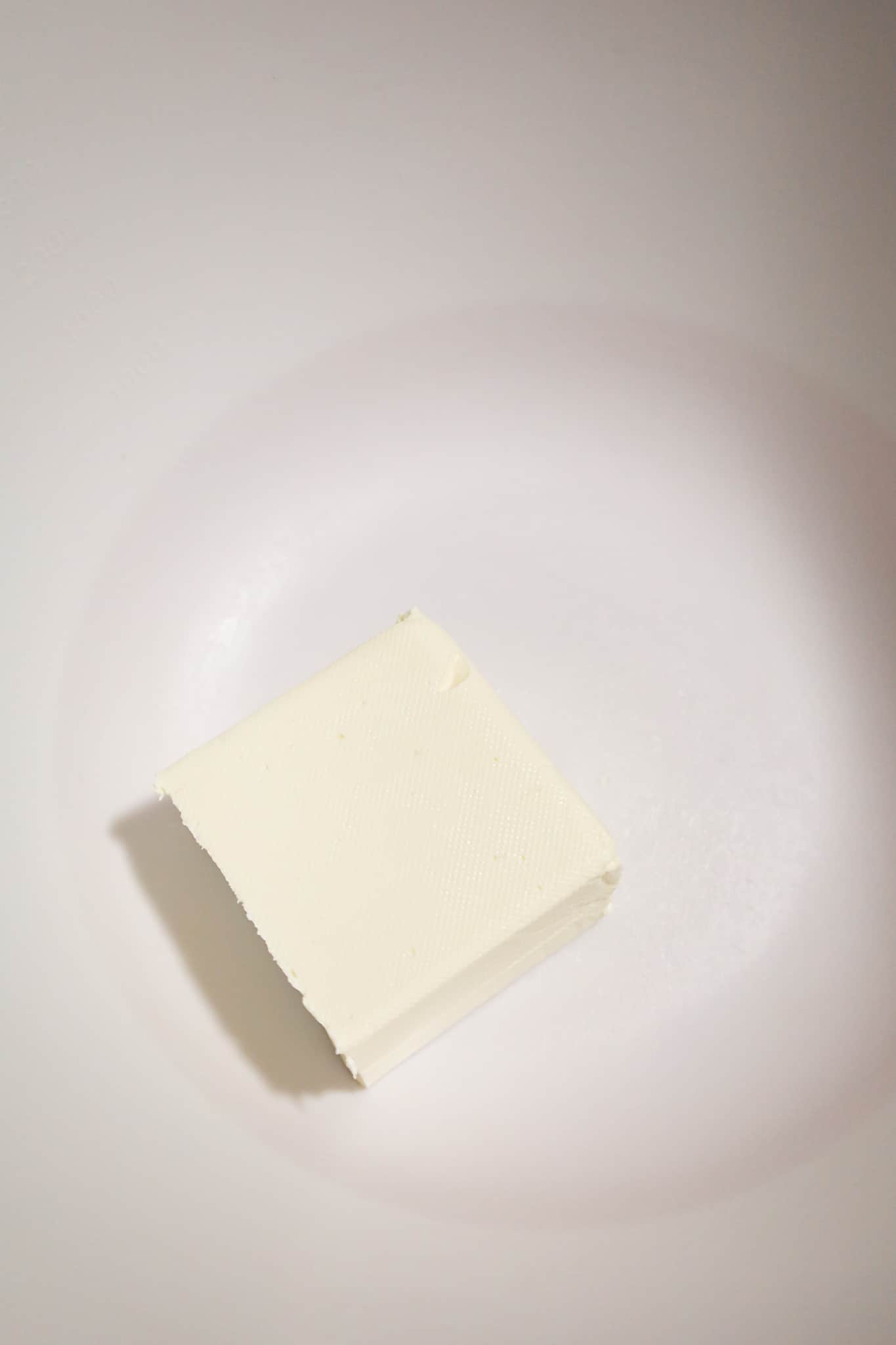 cream cheese block in a mixing bowl