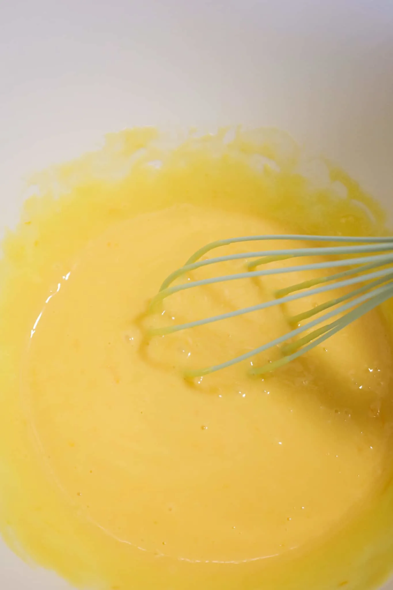 sweetened condensed milk and egg yolks whisked together in a mixing bowl