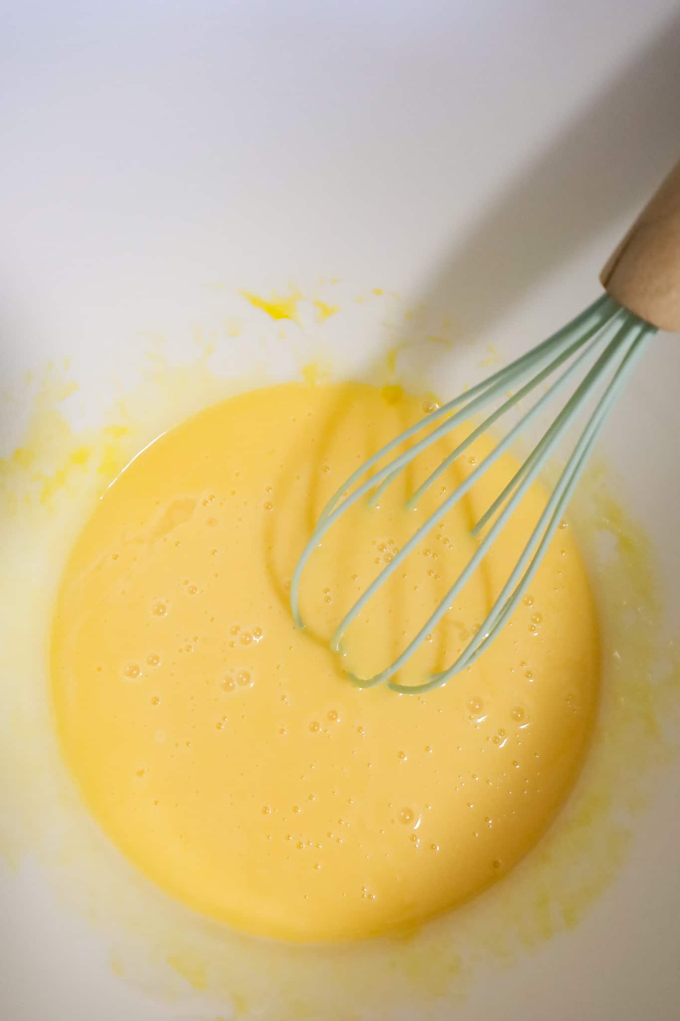 sweetened condensed milk, egg yolks, orange juice and lime juice all whisked together in a mixing bowl