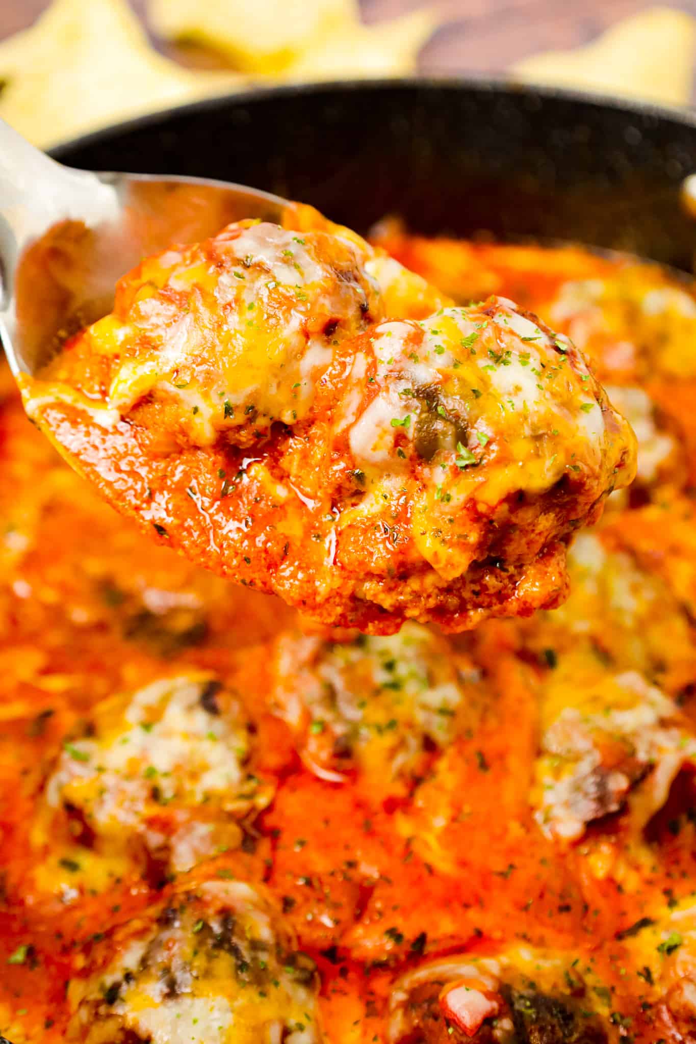 Tex Mex Meatballs are an easy dinner recipe made with ground beef, crushed corn chips, taco seasoning and cheese cooked in a sauce made with tomato sauce and salsa.