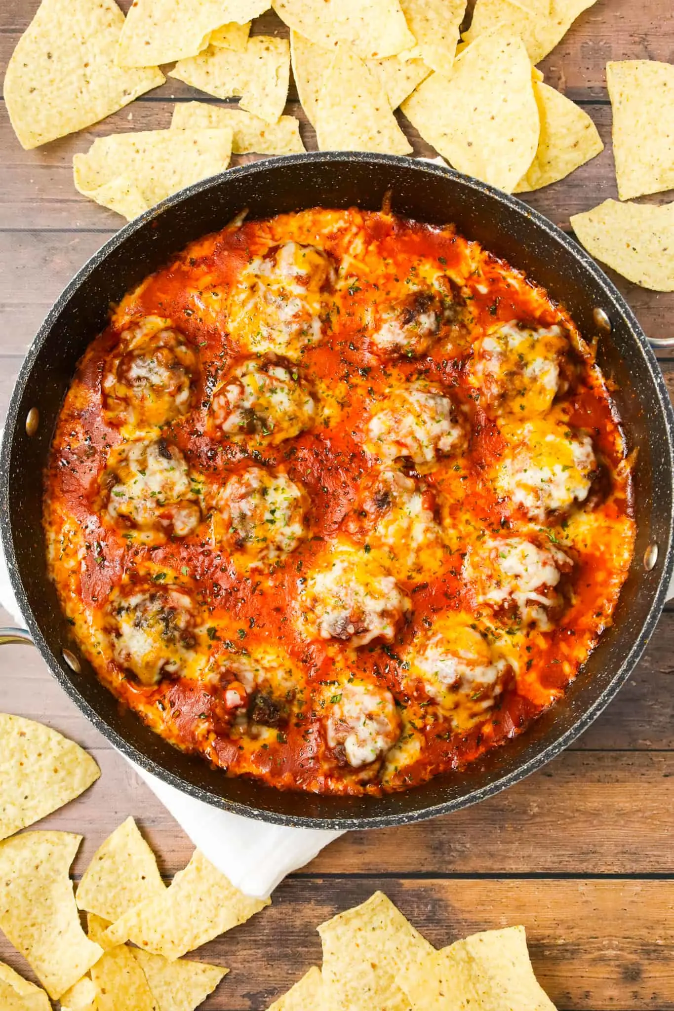 Tex Mex Meatballs are an easy dinner recipe made with ground beef, crushed corn chips, taco seasoning and cheese cooked in a sauce made with tomato sauce and salsa.