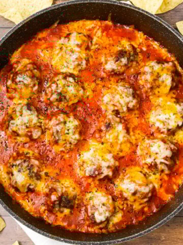 Tex Mex Meatballs are an easy dinner recipe made with ground beef, crushed corn chips, taco seasoning and cheese cooked in a sauce made with tomato sauce and salsa.
